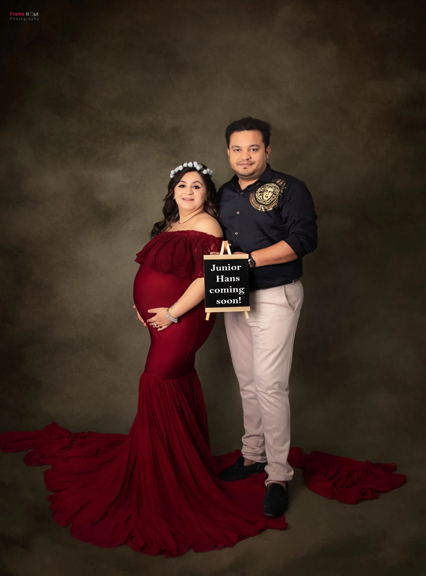 Mother and partner sharing a tender moment during maternity session