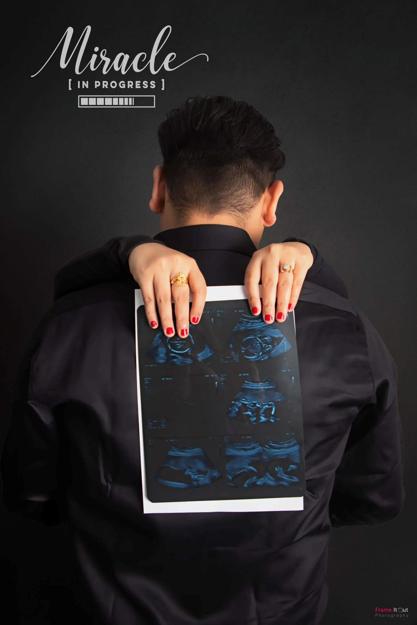 maternity portrait of couple holding ultrasound photo