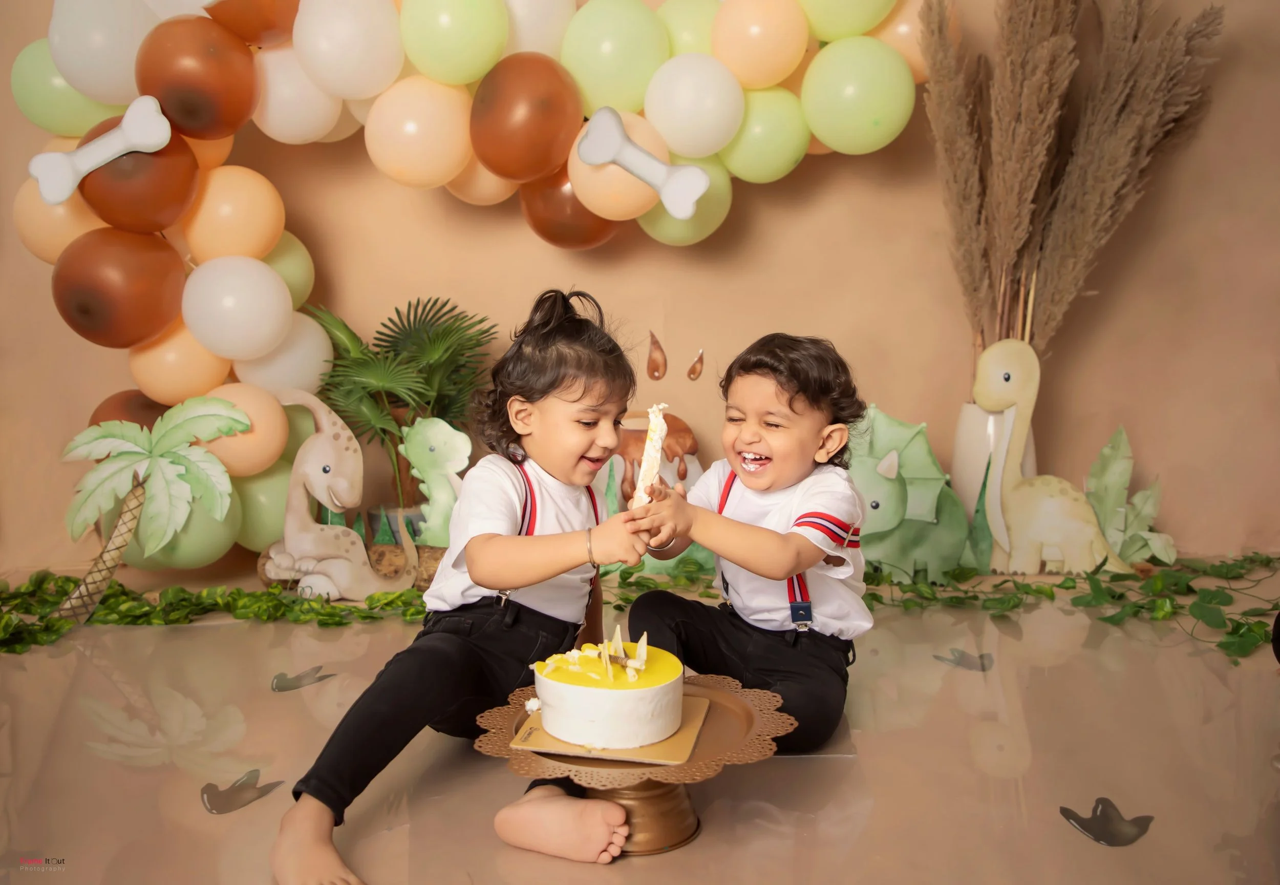 Happy baby celebrating first birthday with cake smash photoshoot in Gurgaon