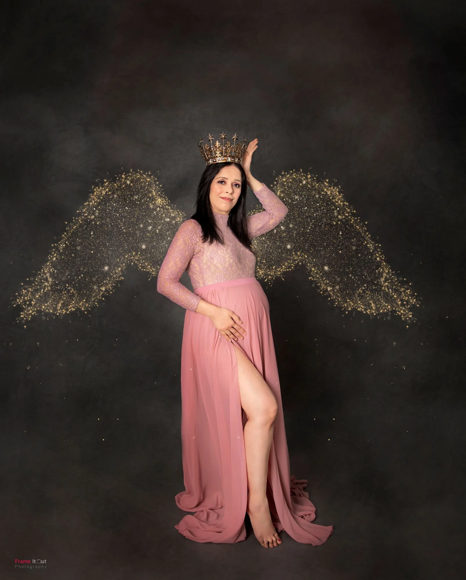 Studio maternity photo of expecting mother in a fitted gown with soft lighting
