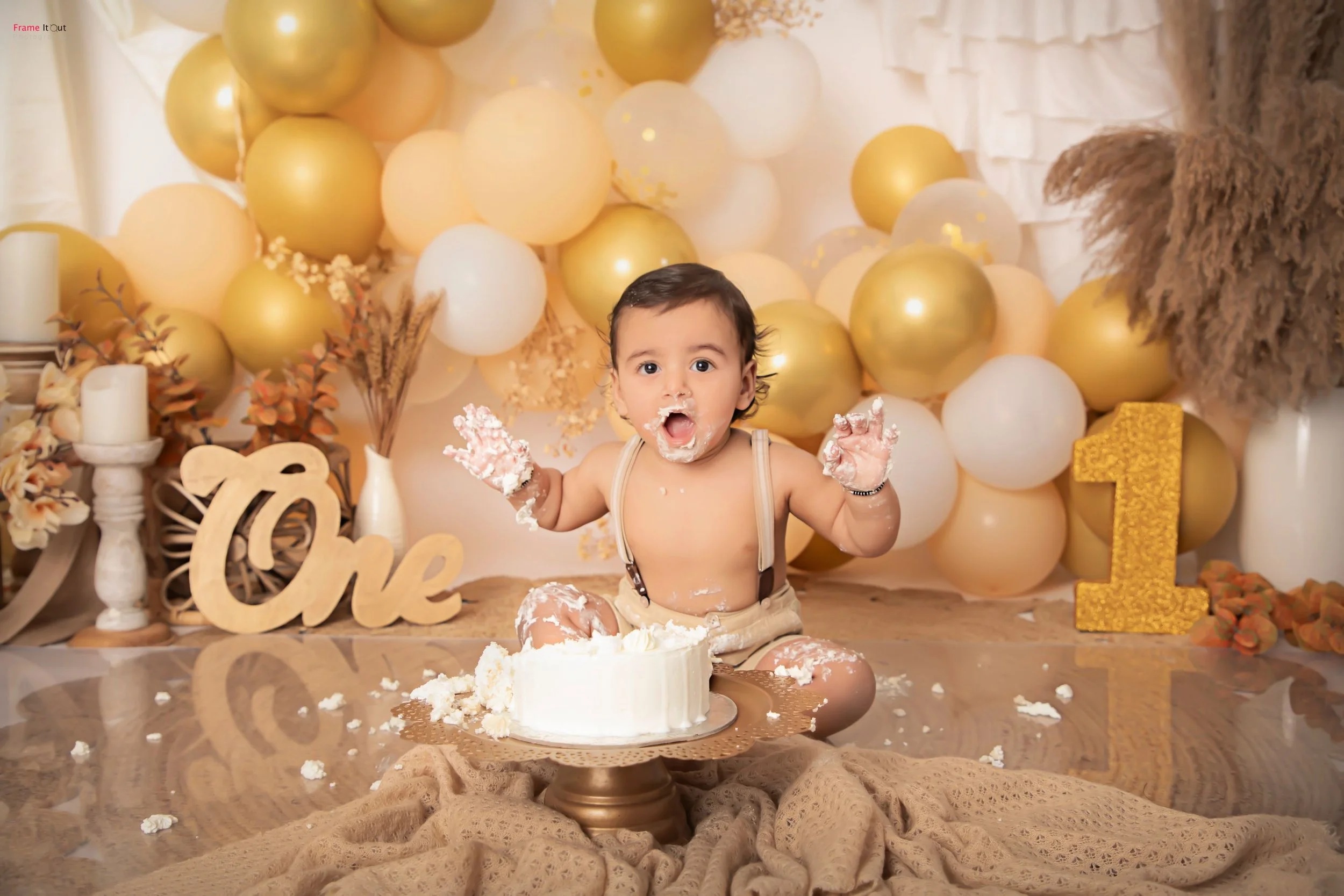 First birthday cake smash photoshoot with themed setup by Frame It Out Photography