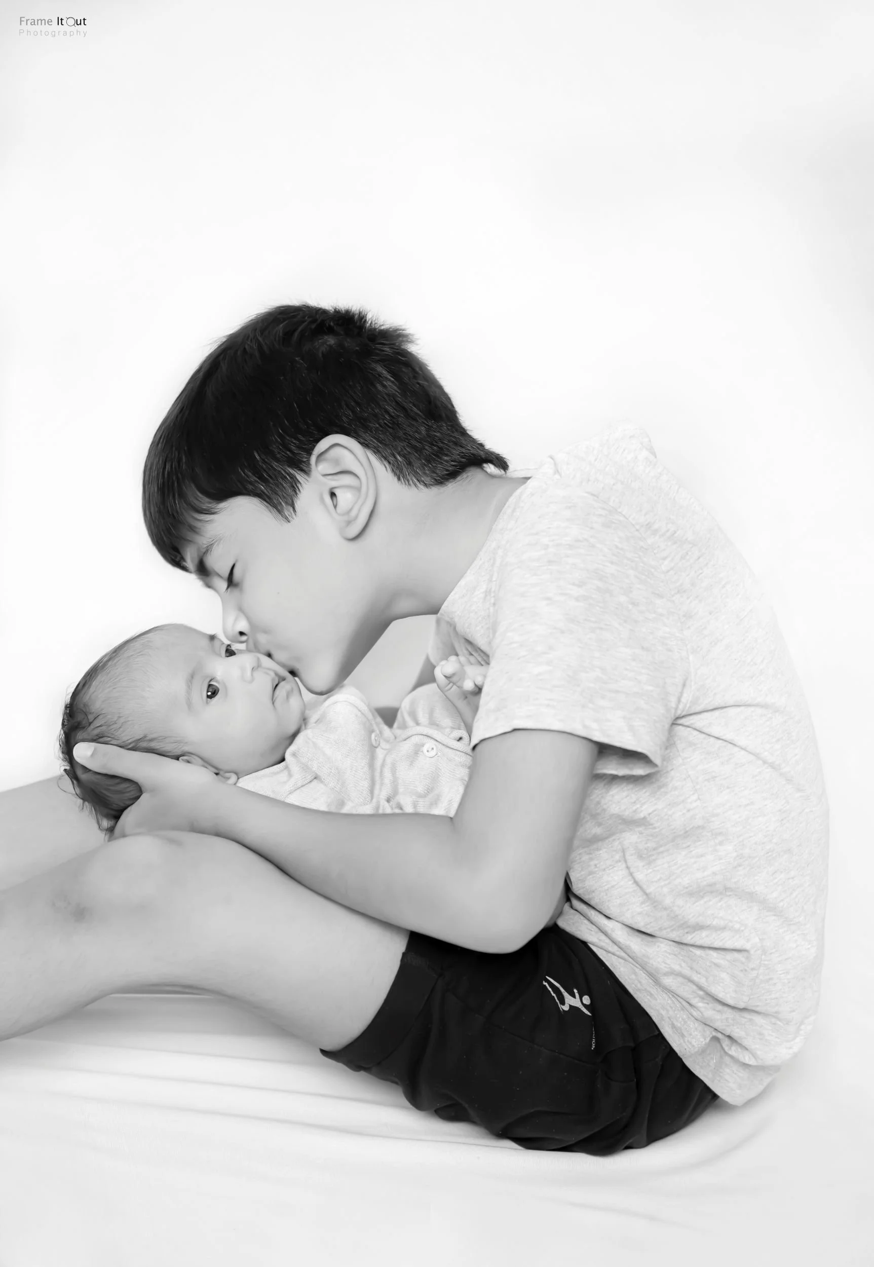 Black and white newborn sibling portrait – luxury photography in Delhi NCR