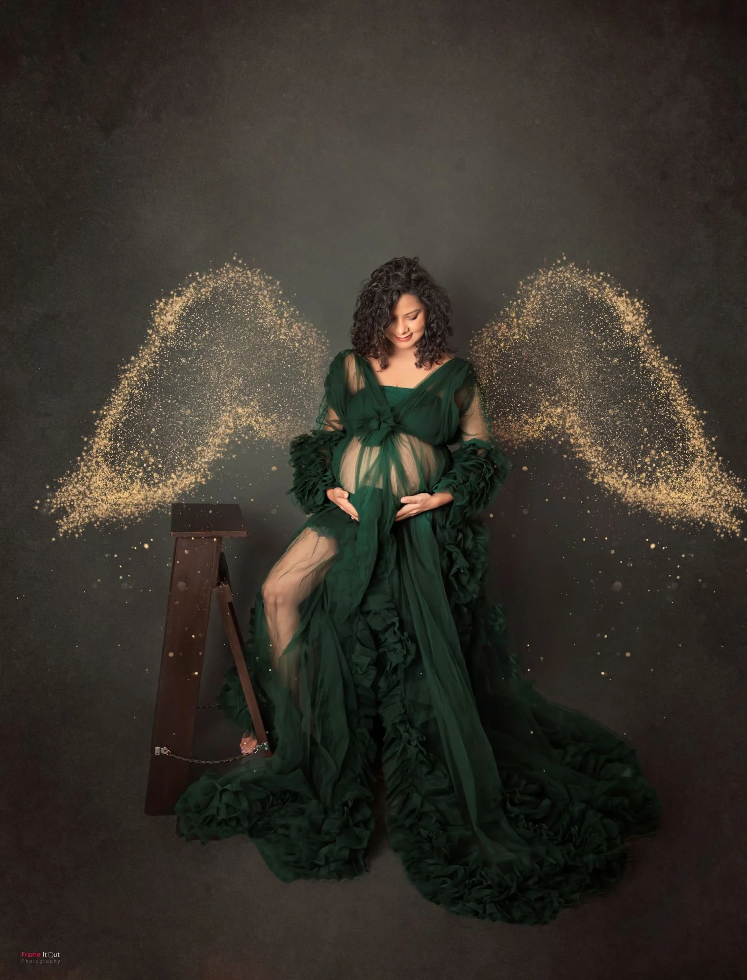 Creative maternity concept shot with dramatic lighting and elegant posing