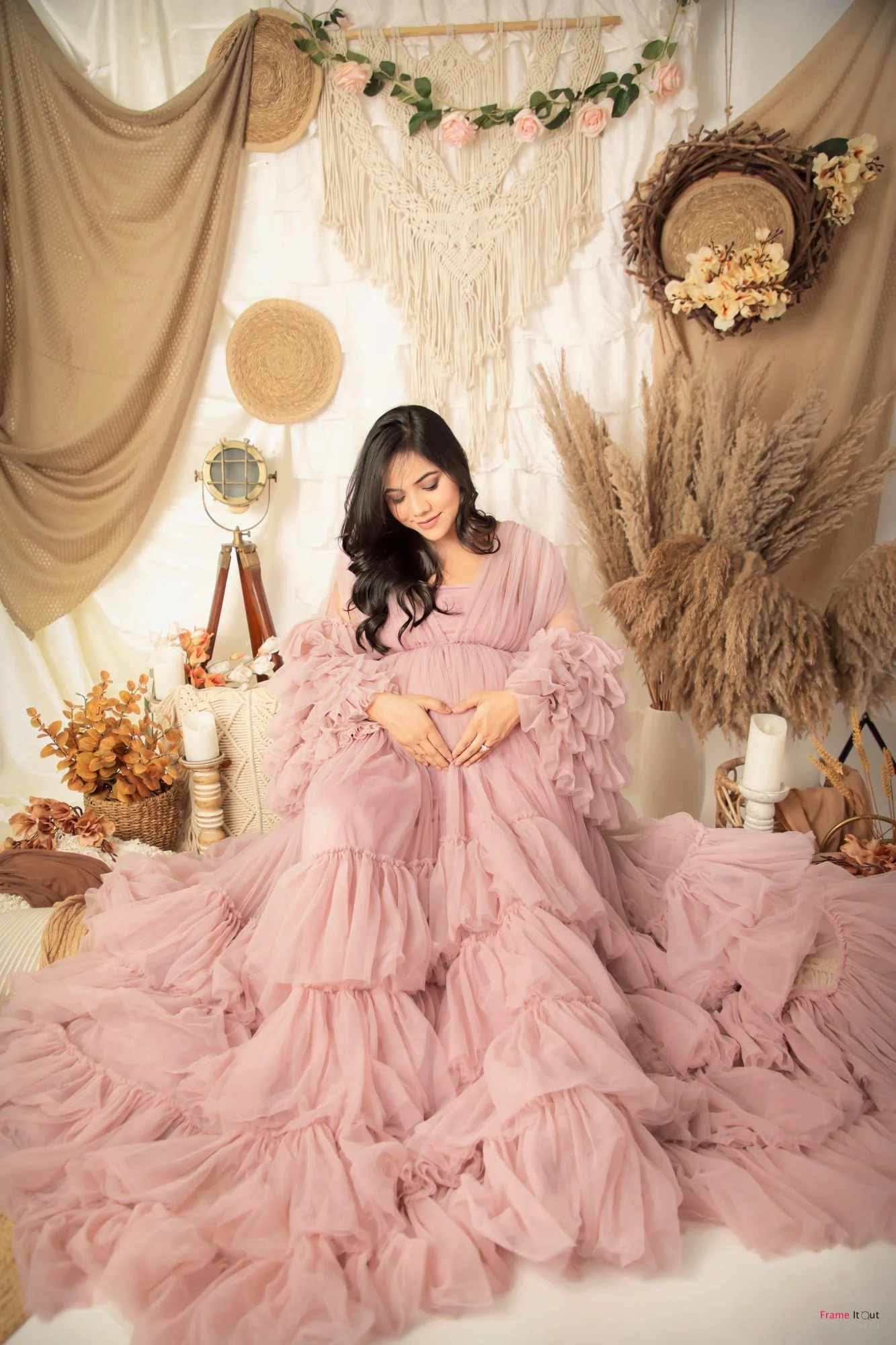 Mother-to-be in pastel gown posing gracefully