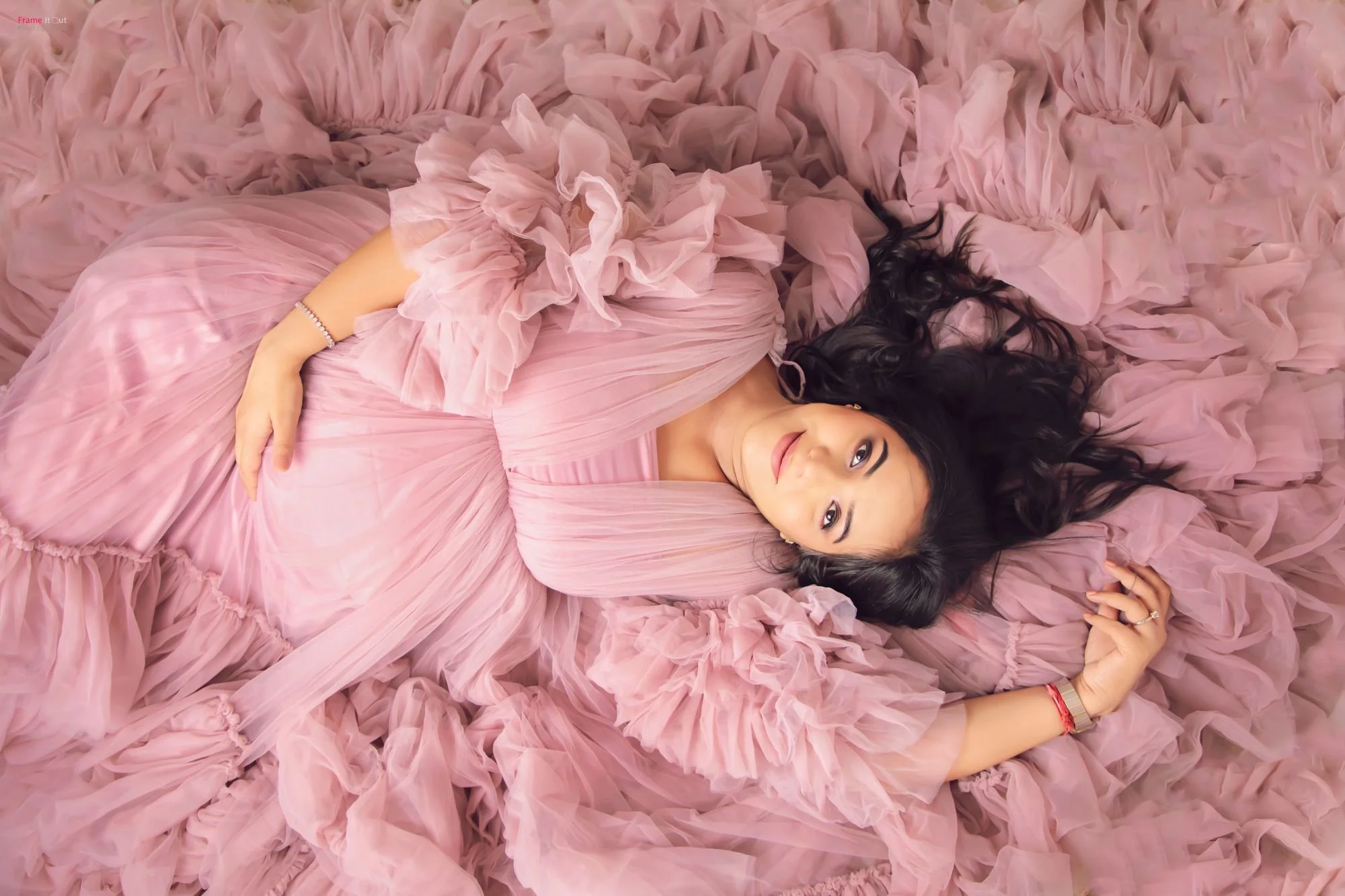 Close-up maternity portrait highlighting baby bump and serene expression