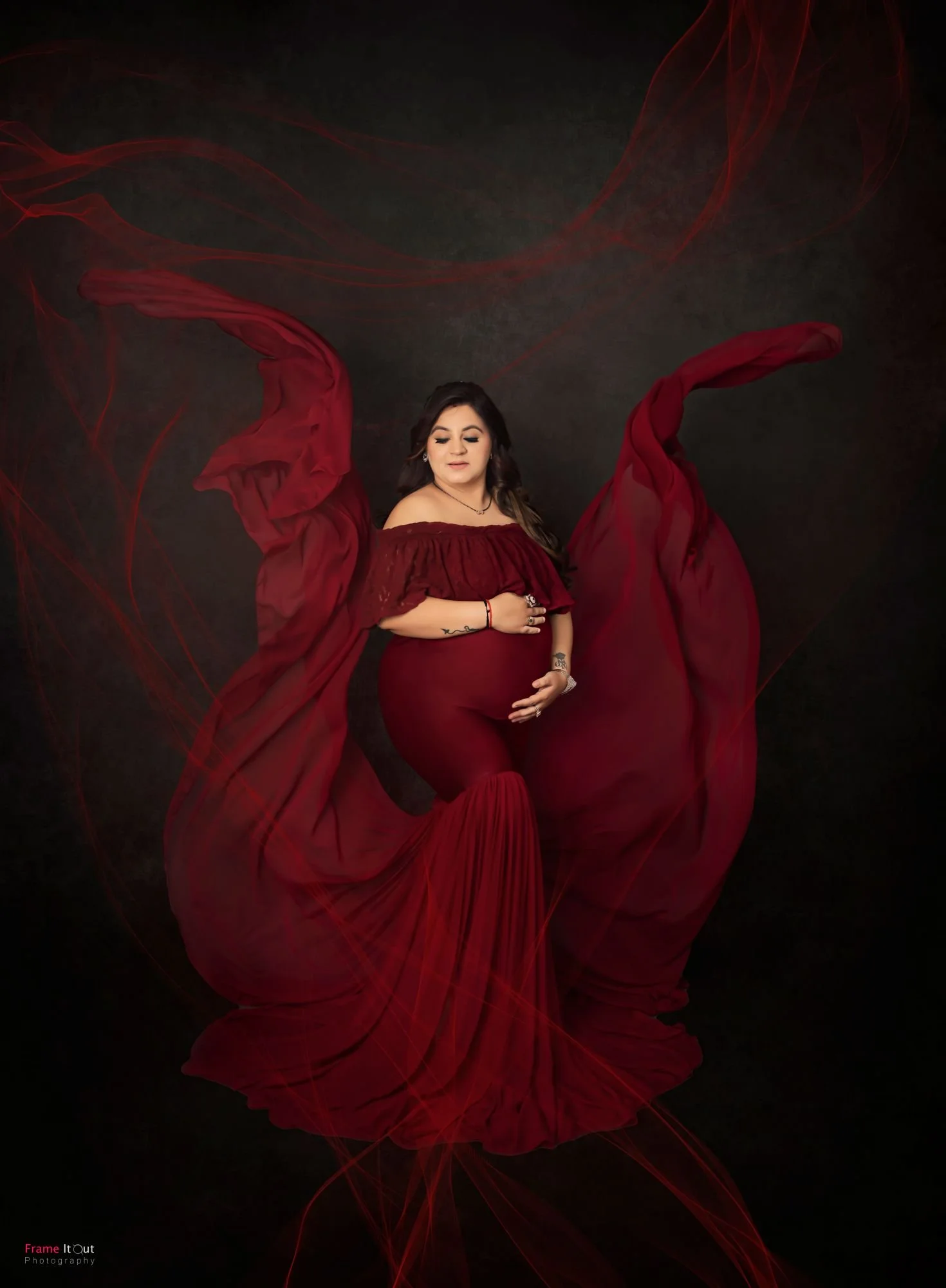 Studio maternity shot with expecting mother holding belly – classic pose