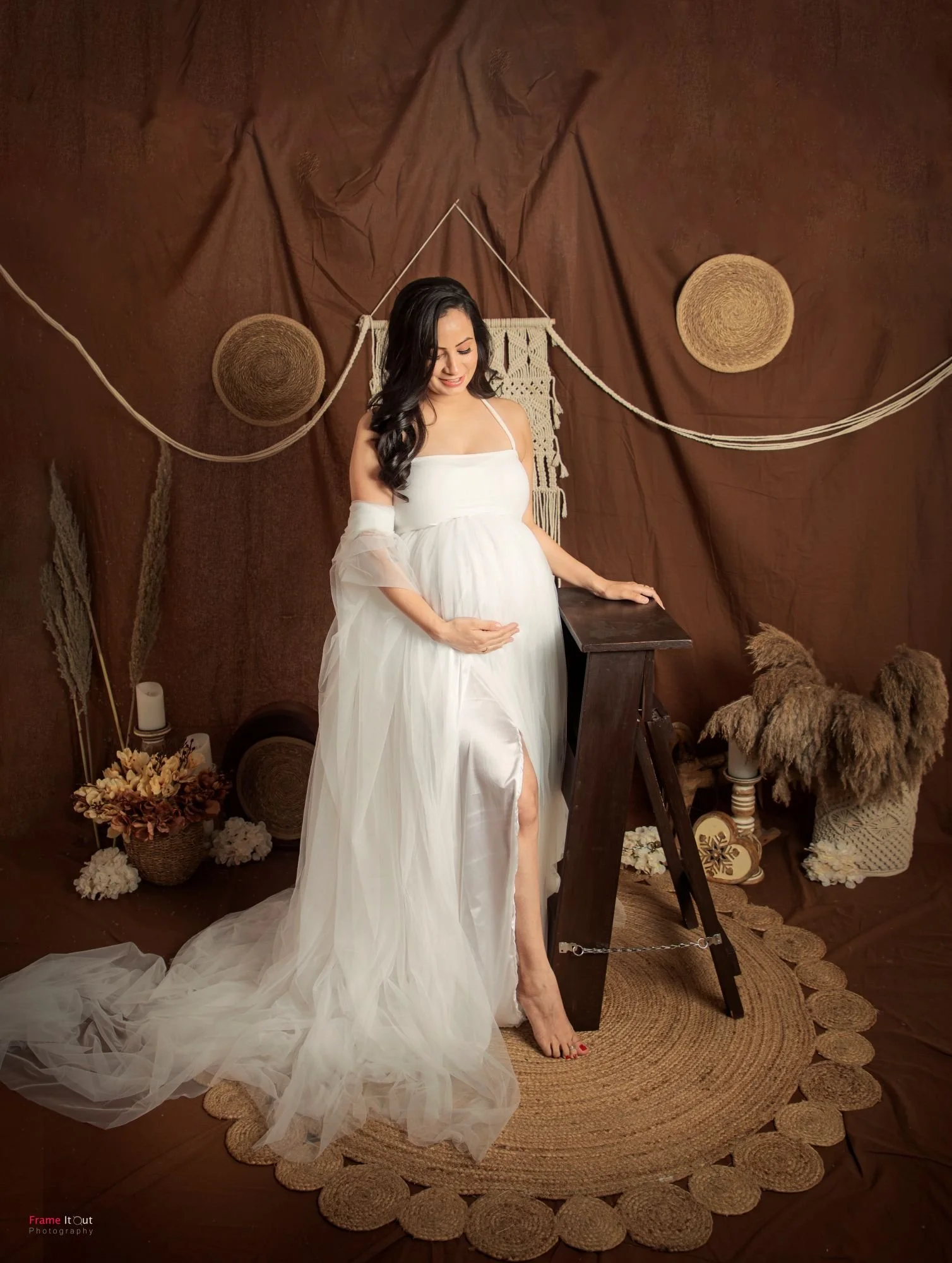 Studio maternity photo of expecting mother in our classic white gown