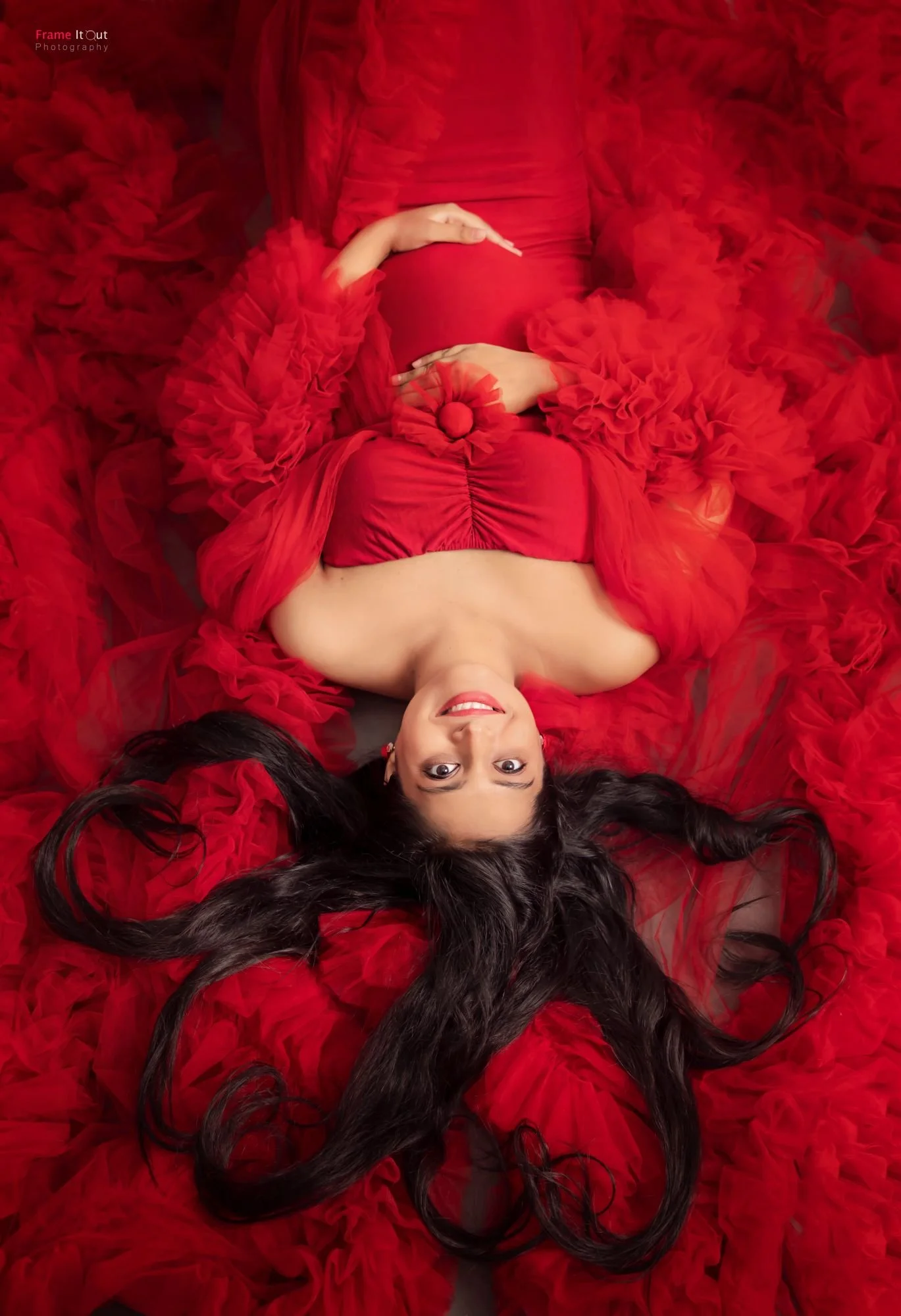 Close-up artistic maternity detail shot with hands on the baby bump