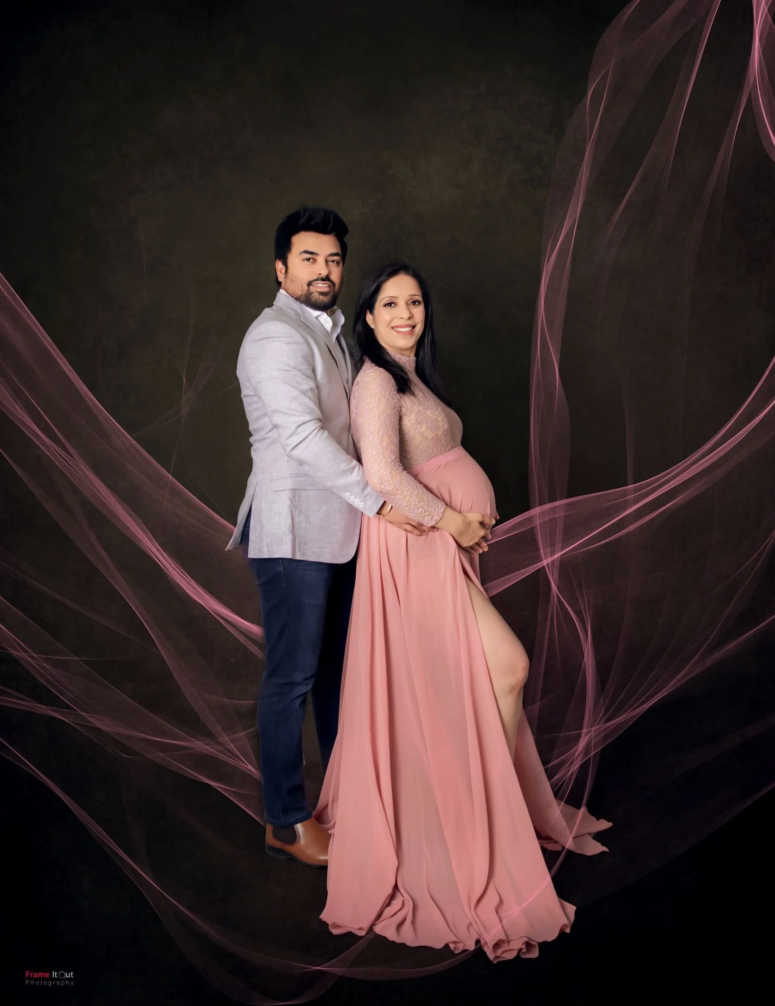Maternity portrait of couple standing close together with soft natural expression