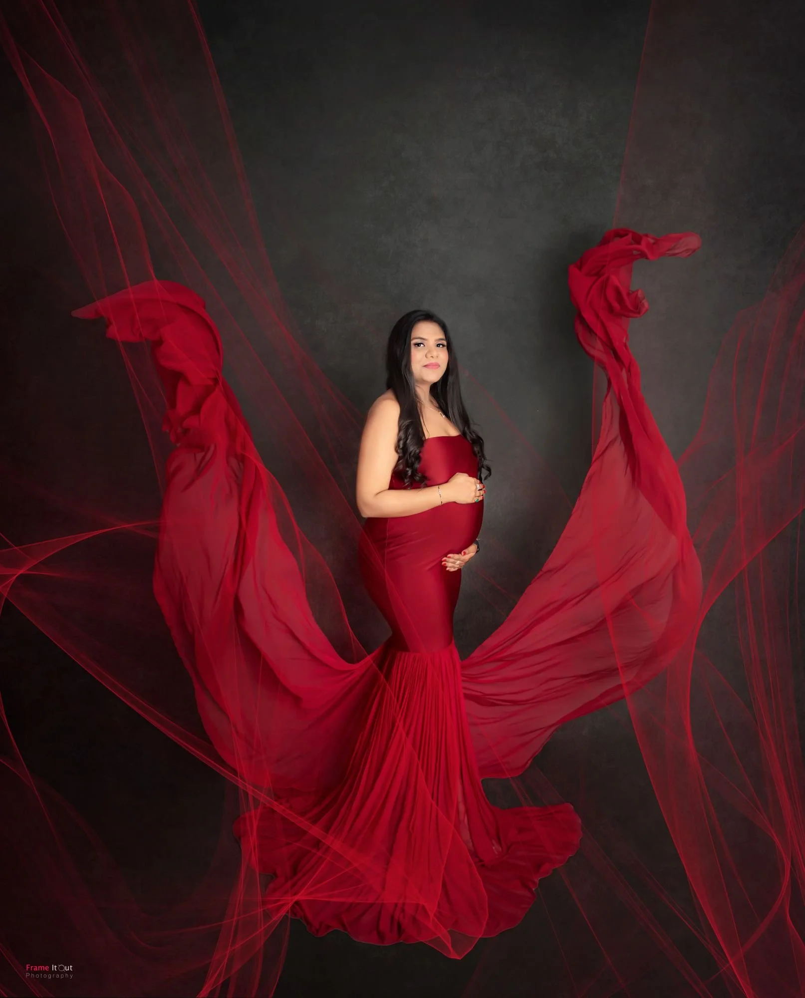 Full-length maternity gown portrait showing flow and movement