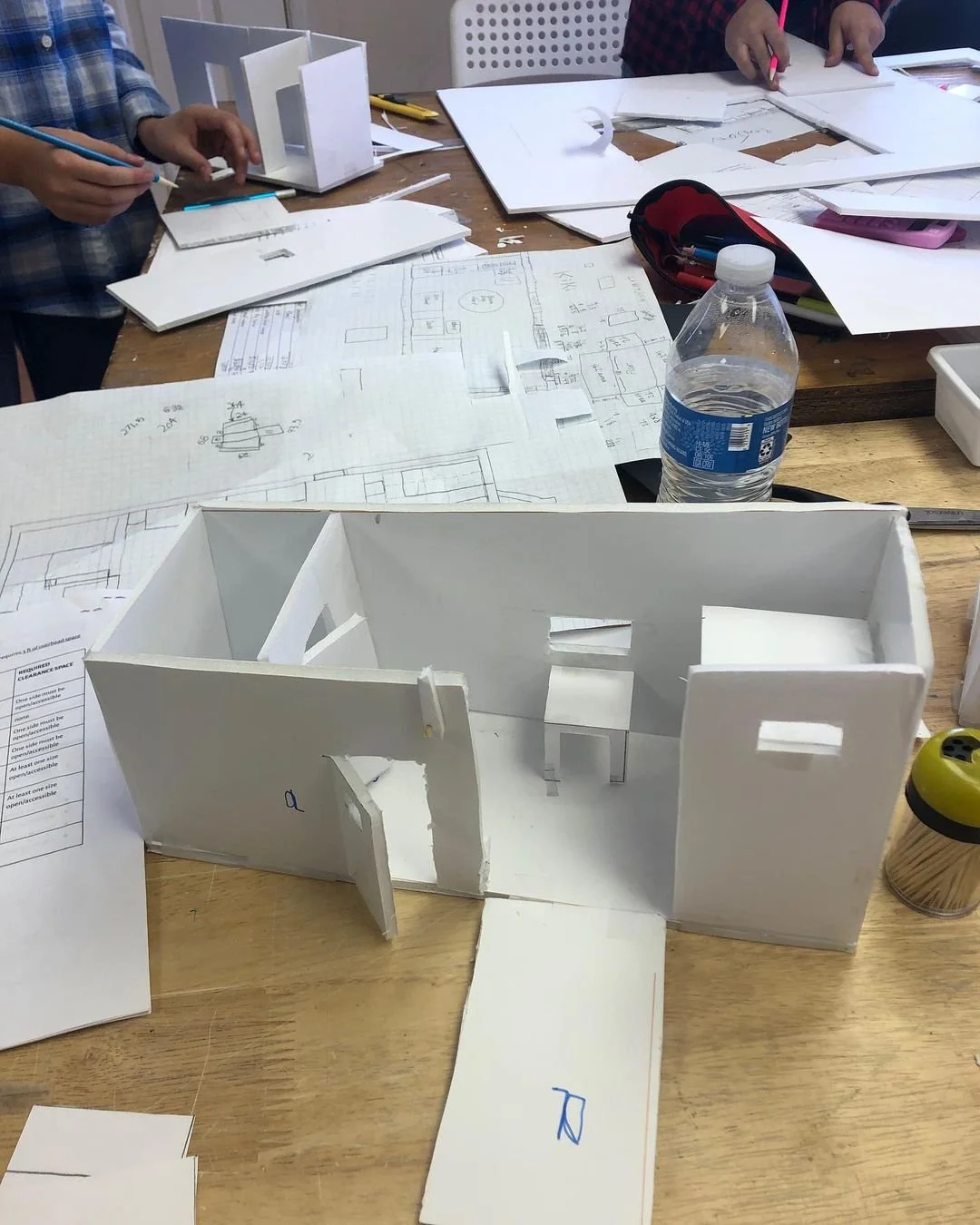 Student work from "Tiny House Challenge" architecture project. 5th-8th graders flexed their math & design to create to-scale models of tiny homes within a preset fictional budget, and researched supply costs, and abided by building regulations, 2019.