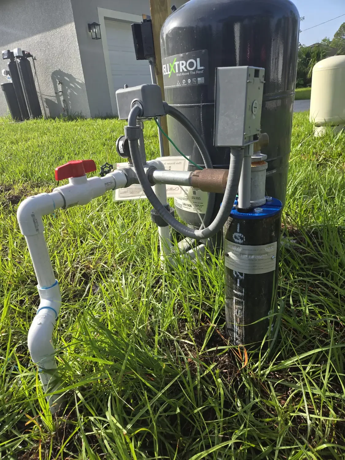 Well water system with pressure tank, control box, and well head