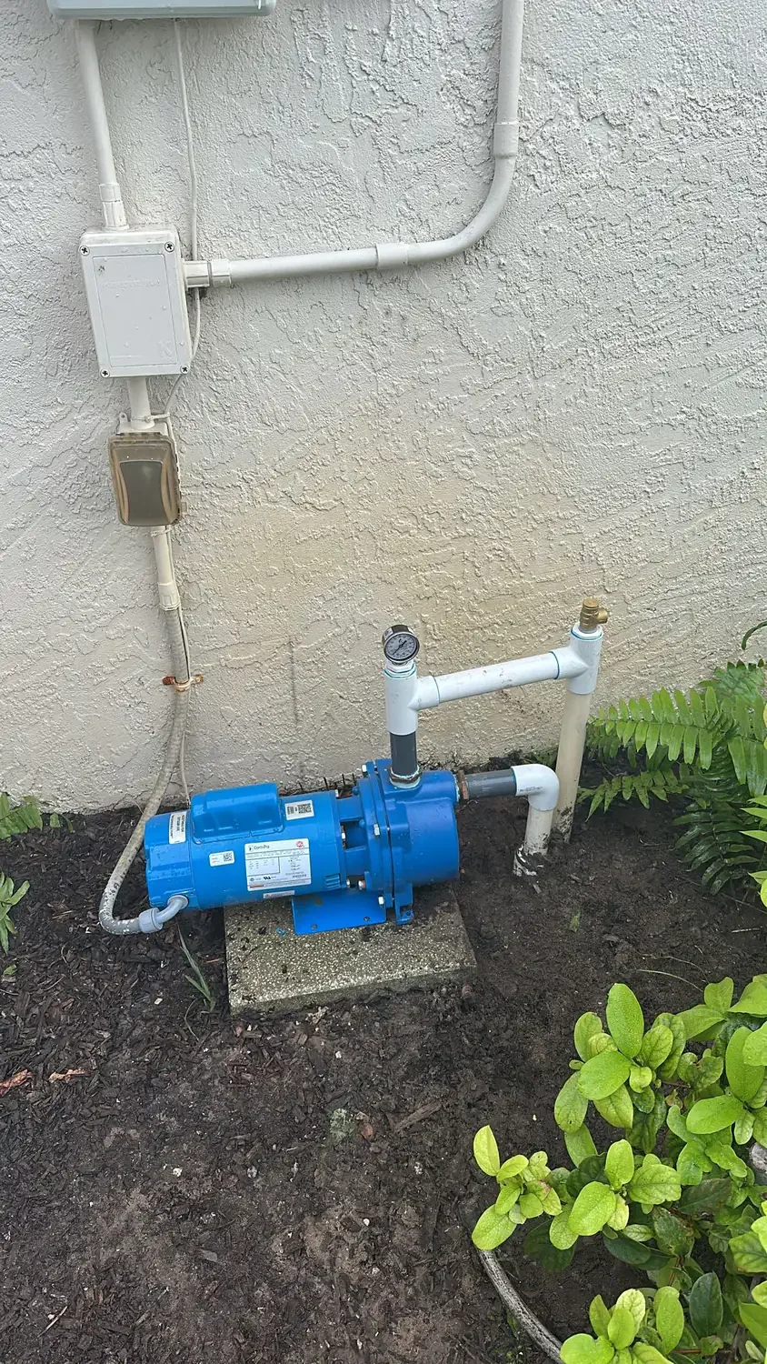 Well pump repair in Sarasota, FL jet pump mounted at the building wall