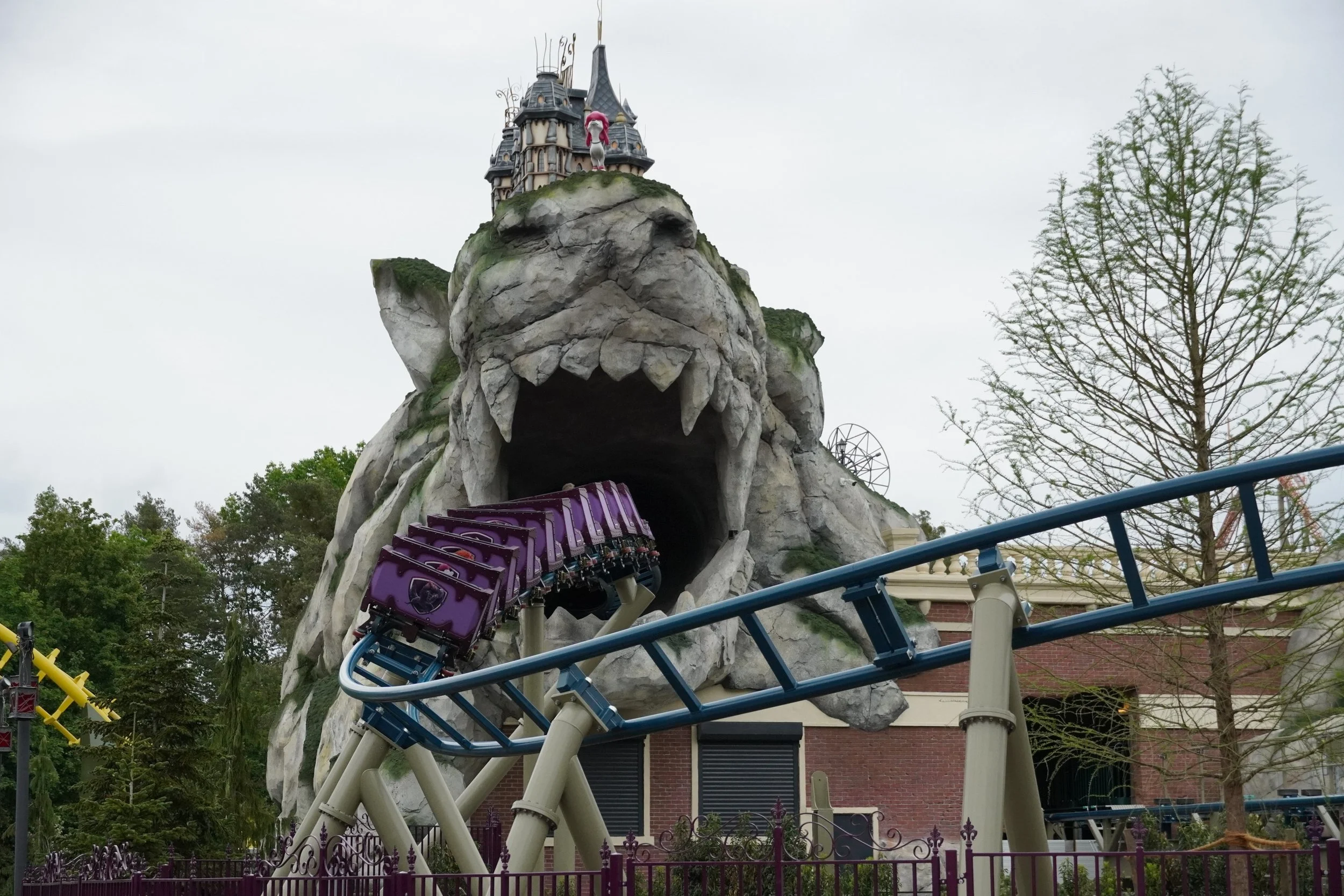 100% Wolf roller coaster train at Plopsaland Deutschland entering wolf rock