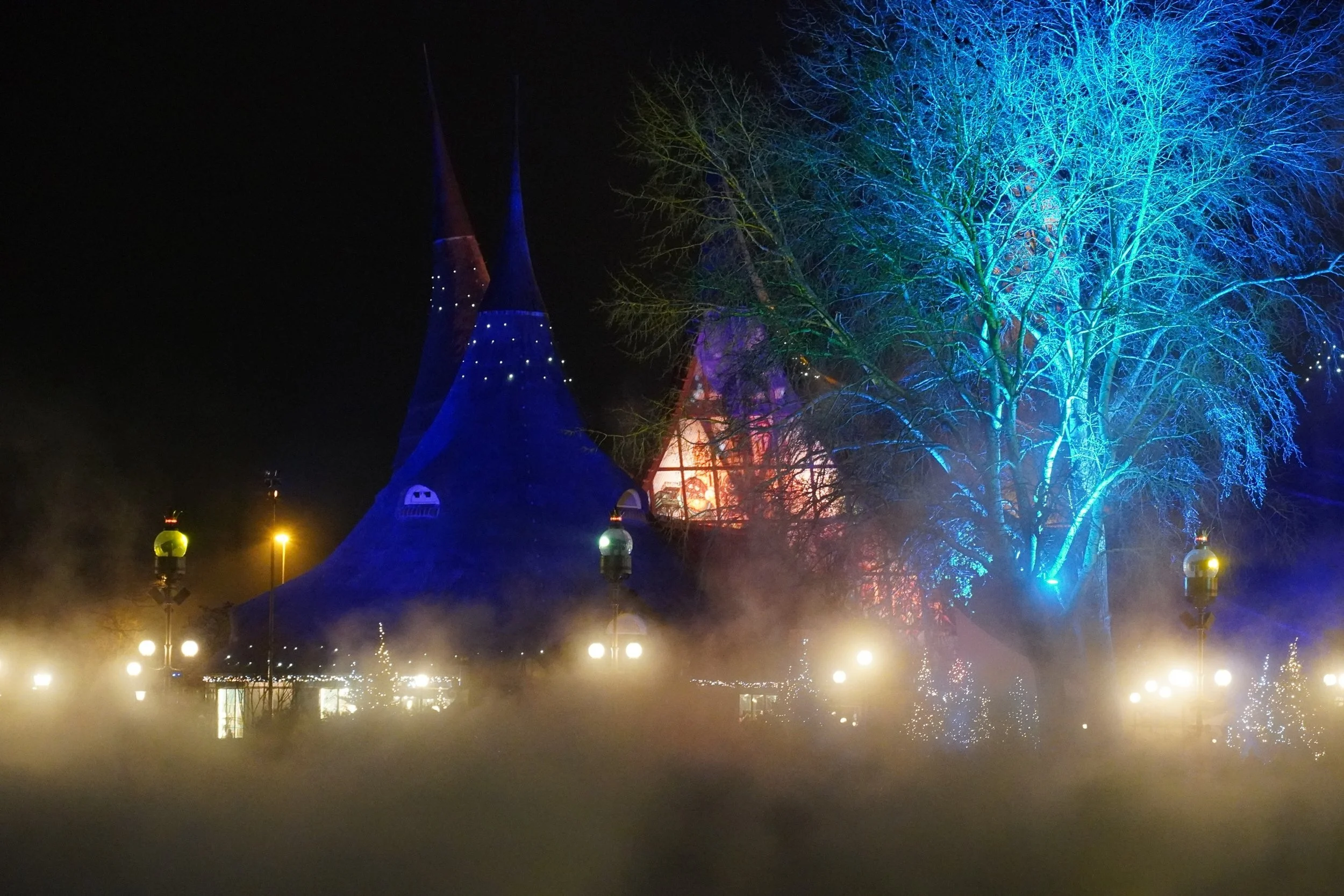House of the Five Senses over Aquanura Water Show at night in Winter Efteling on a Netherlands Theme Park Tour with Coaster Breaks Hoildays