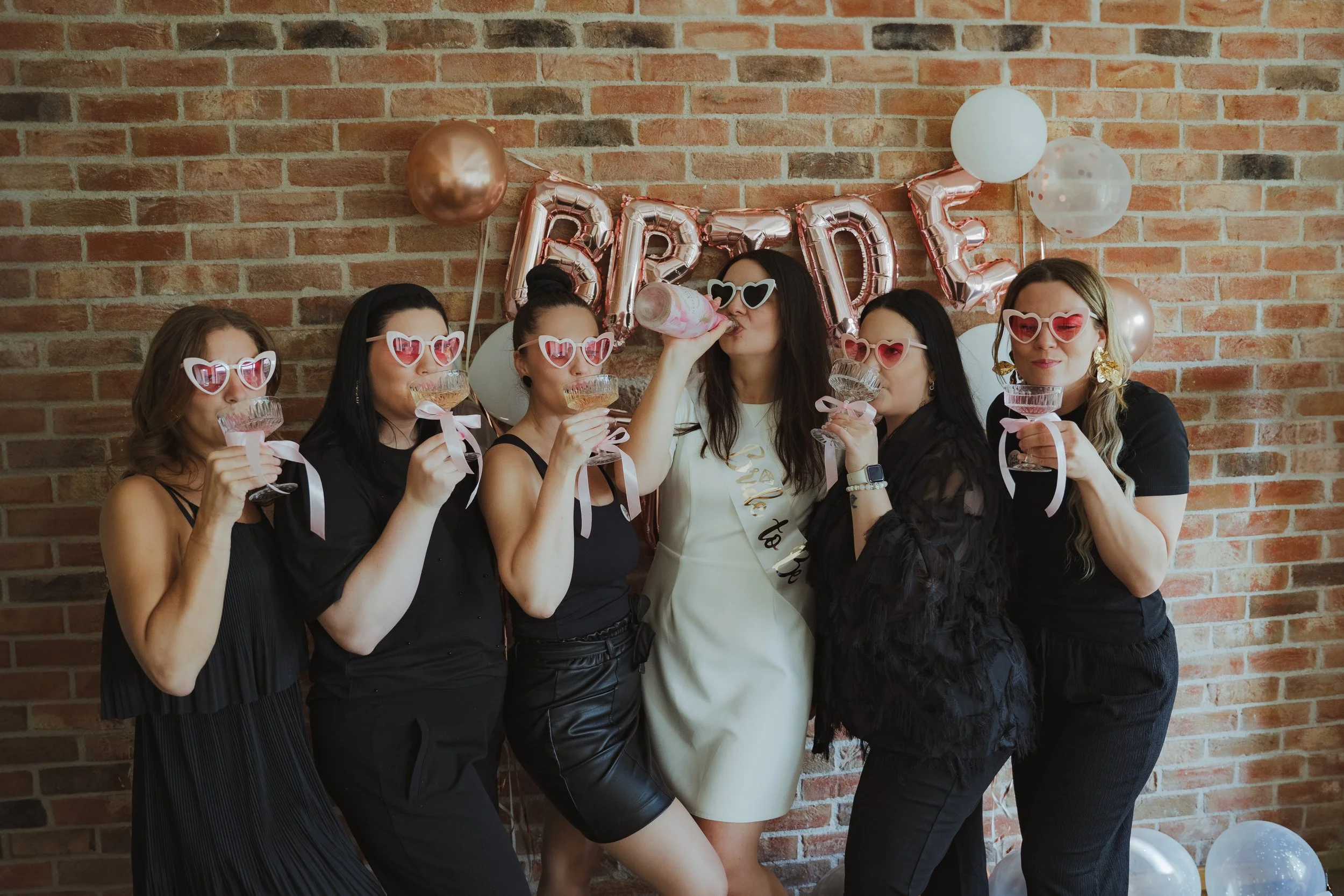 Group of women celebrating a bridal shower with balloons and