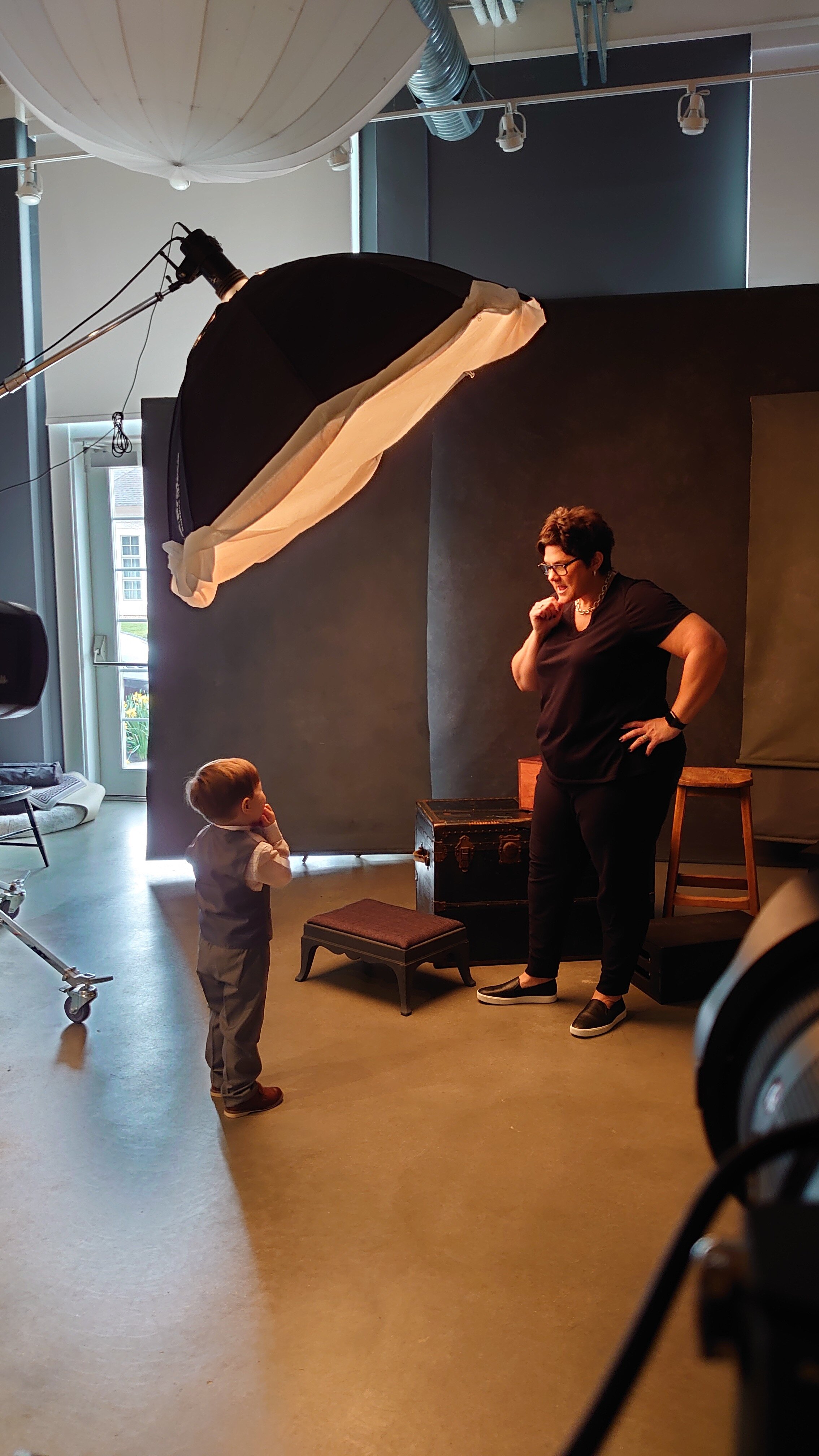 Monica-interacting-with-child-playfully-in-studio-family-session-black-label