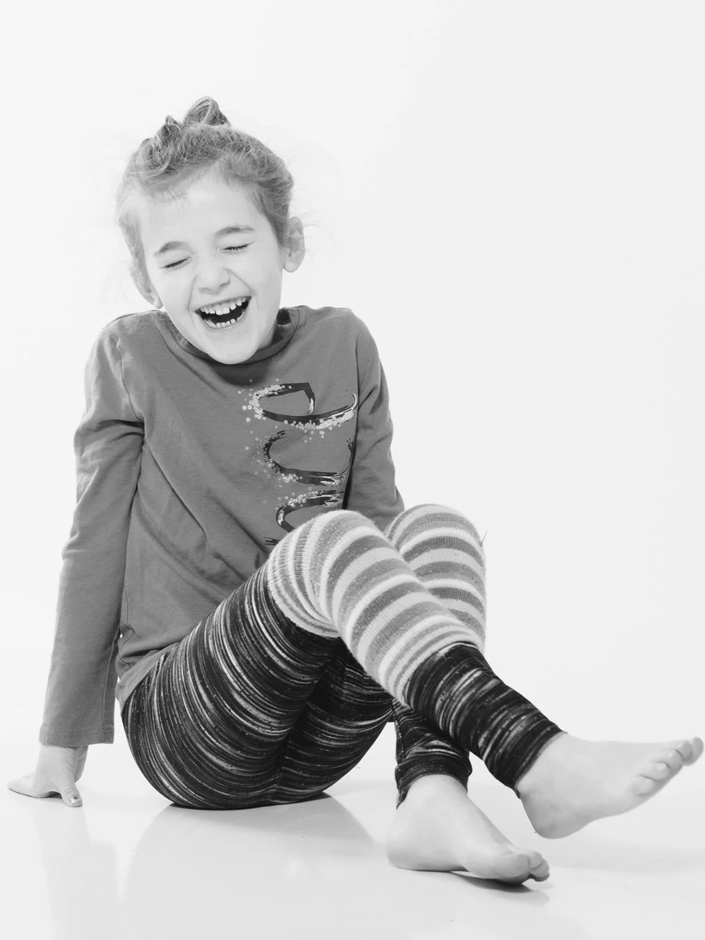 little girl laughing with eyes closed. black and white image on white background. Portsmouth NH