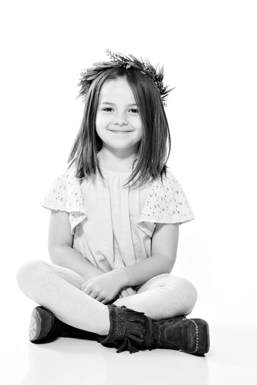 little girl sitting criss cross with a floral crown. black and white image on white background. portsmouth NH