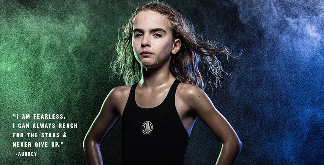 Young girl swimmer against black background, green and blue mist. strong, powerful. Portsmouth NH