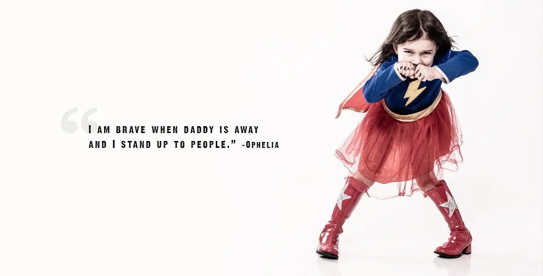 little girl dressed as wonder woman on white background with fearless written on her knuckles. Portsmouth NH