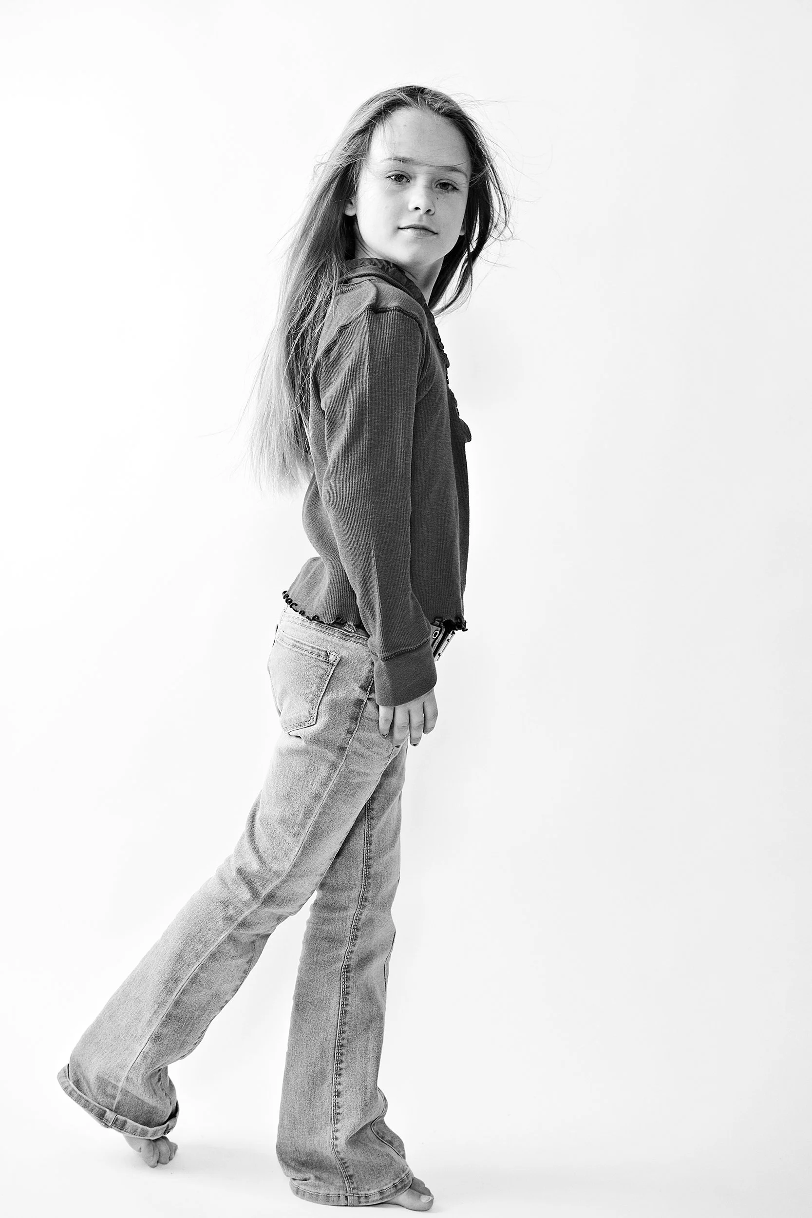 Little girl in jeans and tshirt black and white image on white background. portsmouth NH
