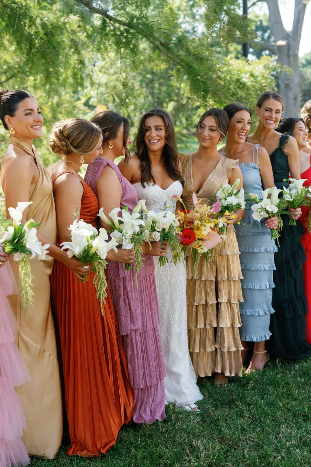 Modern eclectic luxury wedding on the lawn at liberty memorial greenhouse tent wedding outdoor reception fall wedding october the cottage rose kansas city wedding florist crossroads bride bridesmaids colorful dressed white and green bouquets