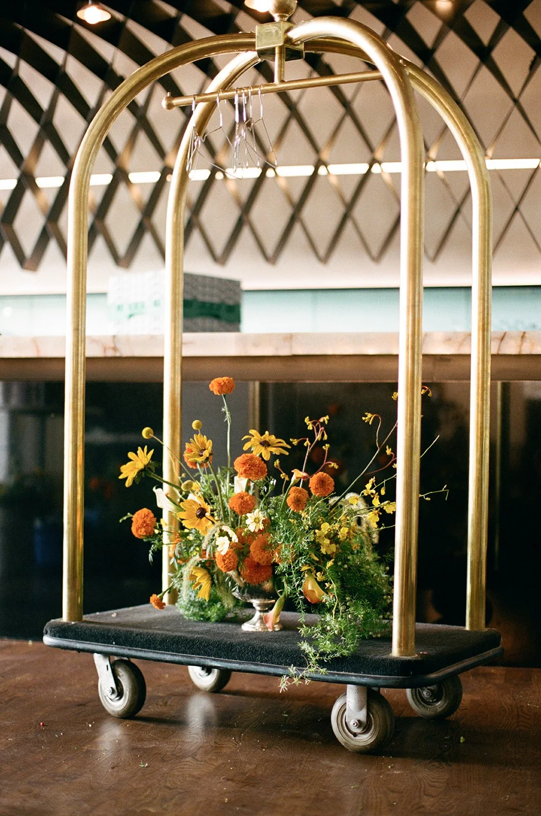 Modern september wedding orange and yellow color palette seasonal flowers calla lilies marigolds bar arrangement wedding bridal portraits the cottage rose kansas city wedding florist crossroads hotel kansas city wedding