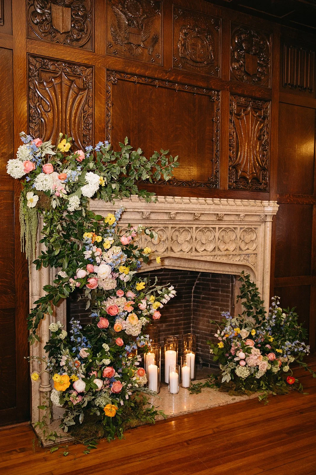 candlelit whimiscal spring garden wedding pastel color palette same sex wedding ceremony fireplace floral installation aisle flowers downtown kc hotel kansas city the cottage rose kansas city wedding florist crossroads