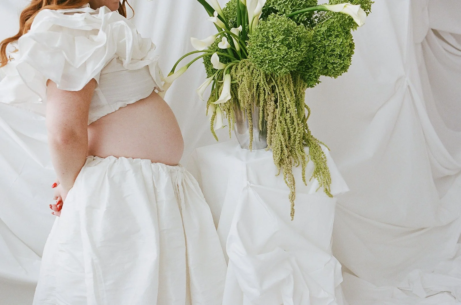Chic Modern Baby Shower in a Cloud with layers of white draped fabric, simple calla lily centerpieces,  silver candlesticks, hanging floral installation the cottage rose kansas city florist crossroads green hydrangea green amaranth