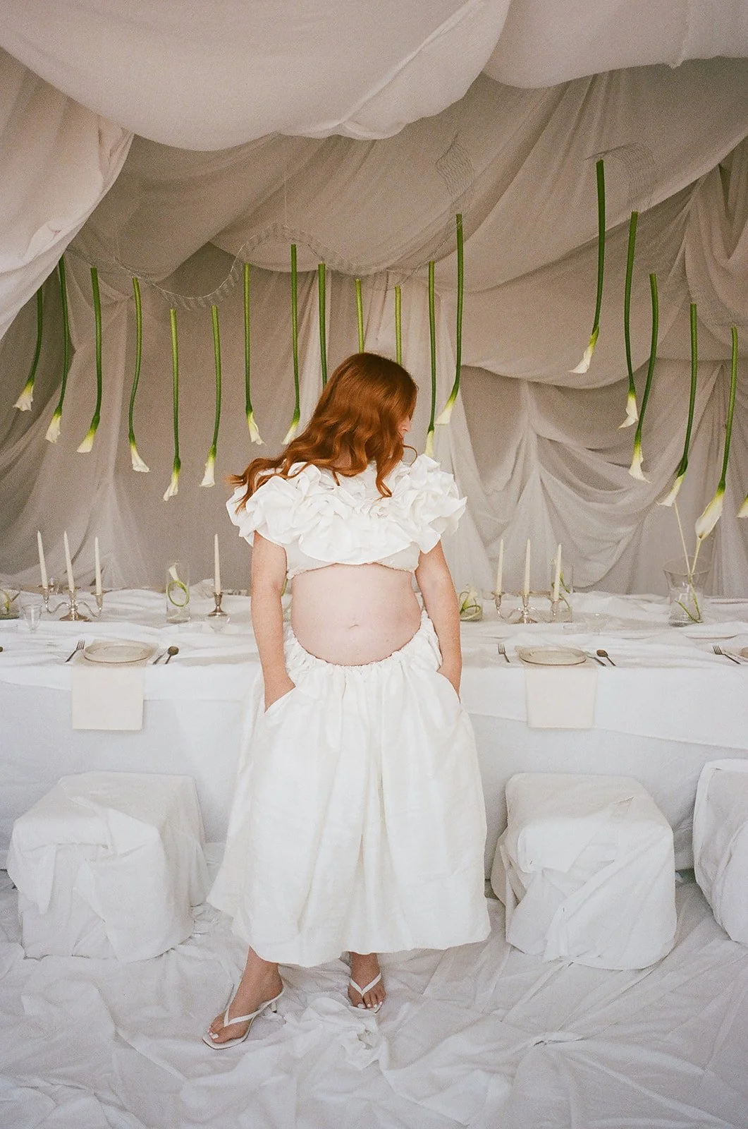 Chic Modern Baby Shower in a Cloud with layers of white draped fabric, simple calla lily centerpieces,  silver candlesticks, hanging floral installation the cottage rose kansas city florist crossroads white set