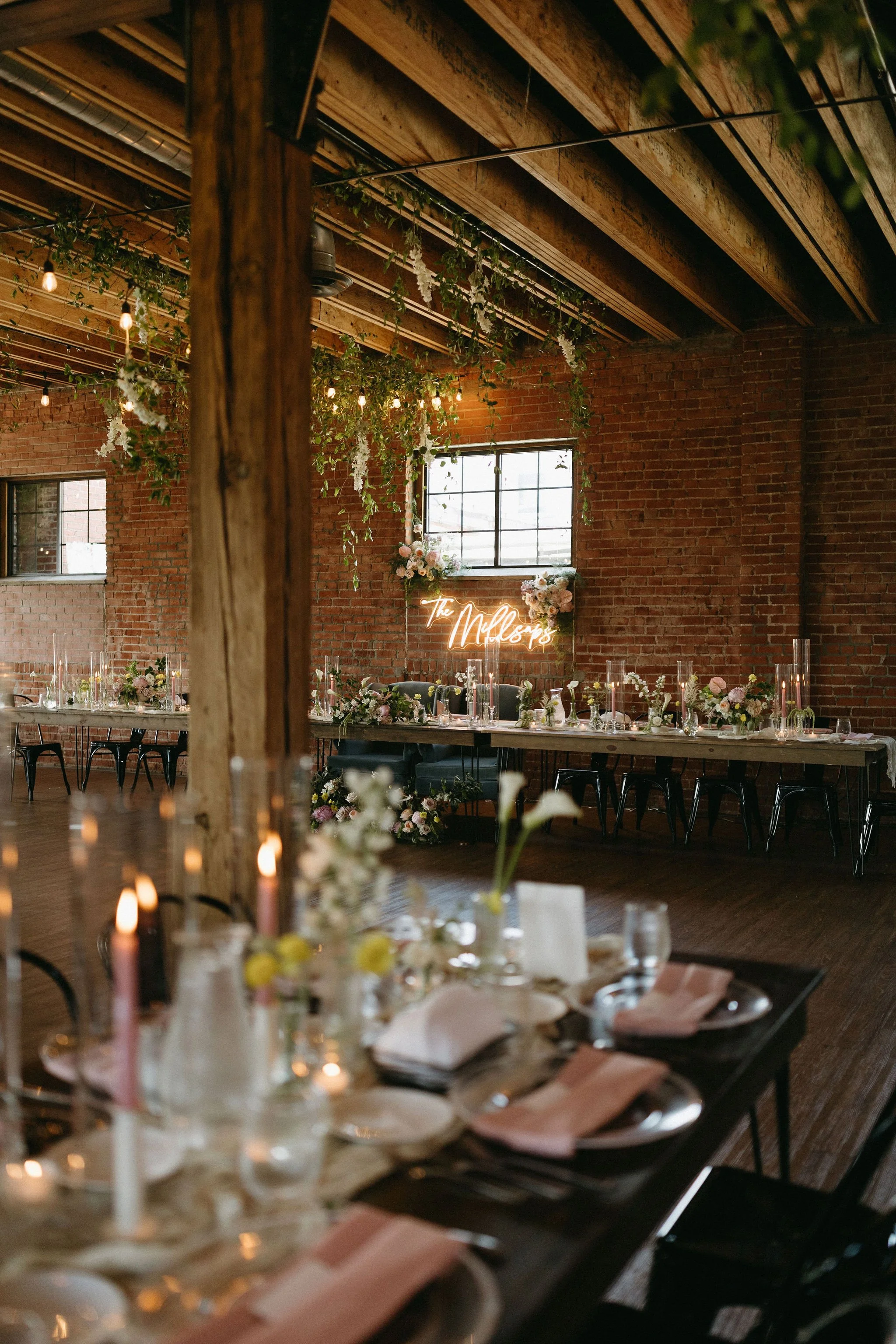 modern spring garden wedding warm color palette yellow peach lilac the cottage rose kansas city florist crossroads powell garden reception hanging greenery bud vases taper candles ikebana flower arrangements centerpieces head table decor