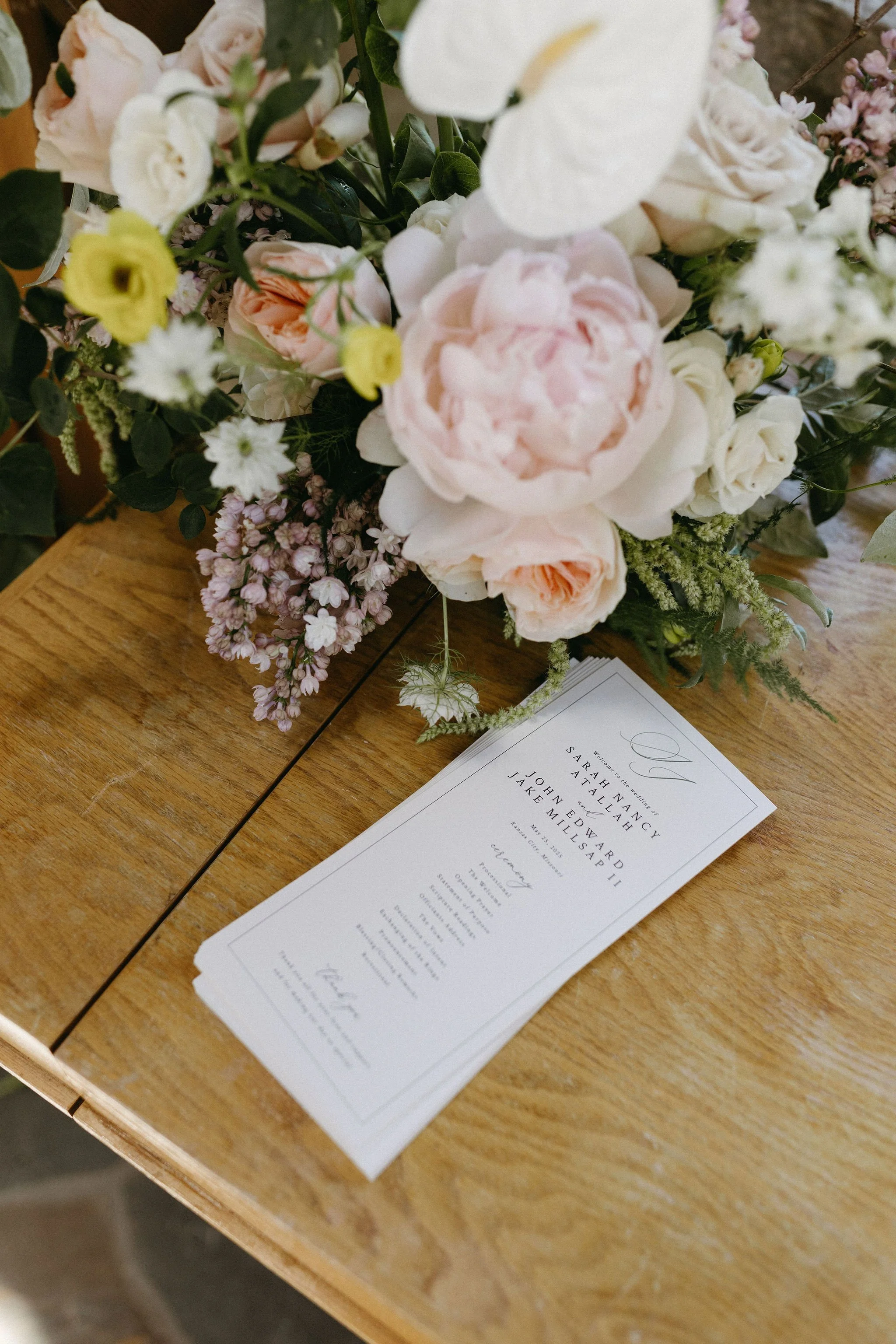 modern spring garden wedding warm color palette yellow peach lilac the cottage rose kansas city florist crossroads powell garden ceremony welcome arrangement peonies anthurium garden roses ranunculus