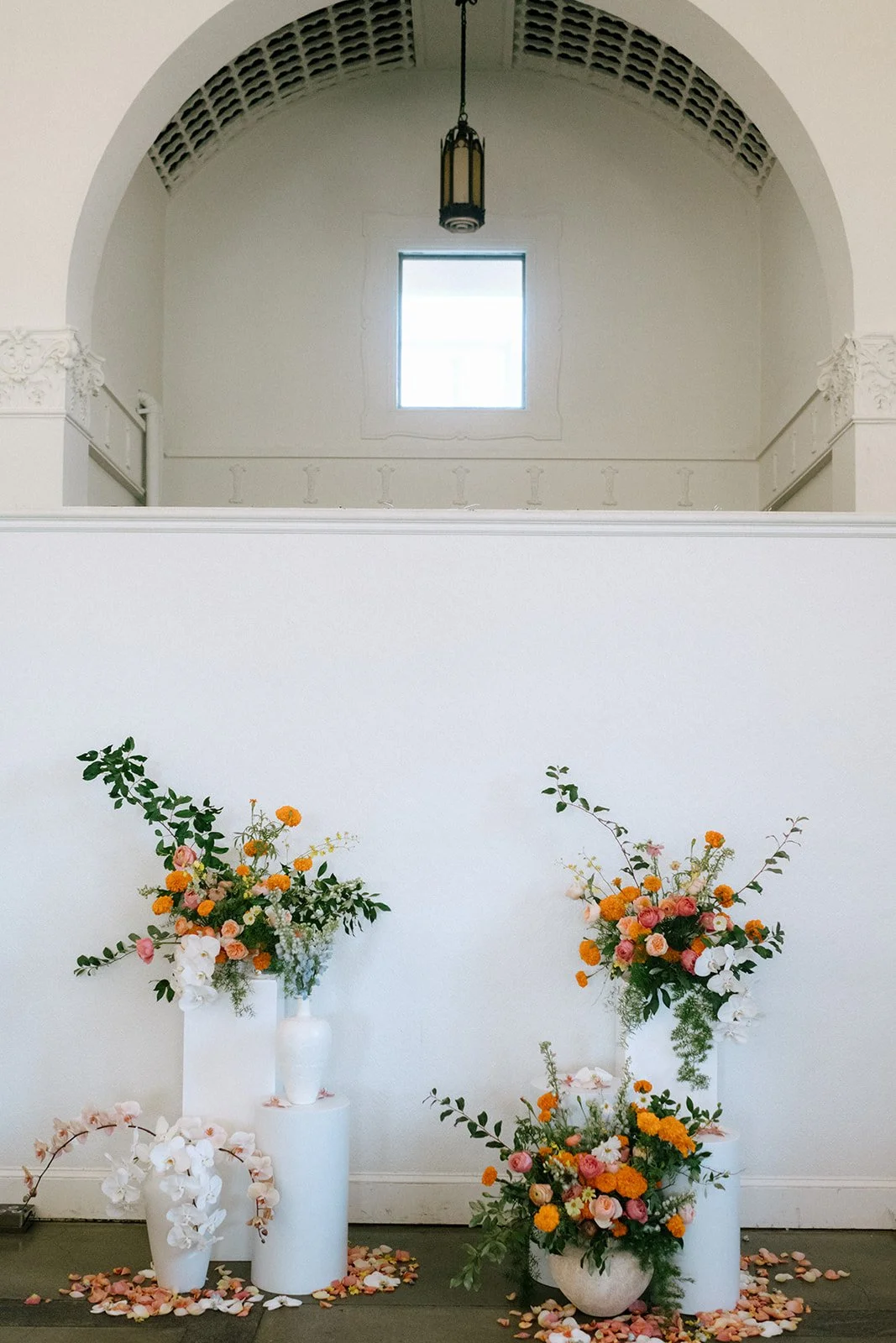 colorful flower filled october wedding in midtown kansas city la villa bridal bouquet wedding bouquet wedding flowers orchids garden roses ranunculus the cottage rose kansas city wedding florist crossroads ceremony pedestal flower arrangement