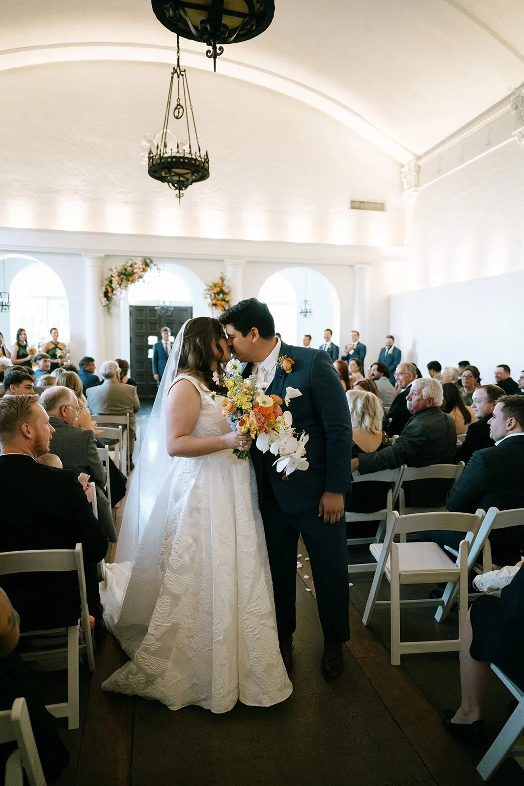 colorful flower filled october wedding in midtown kansas city la villa bridal bouquet wedding bouquet wedding flowers orchids garden roses ranunculus the cottage rose kansas city wedding florist crossroads ceremony hanging flower arrangement