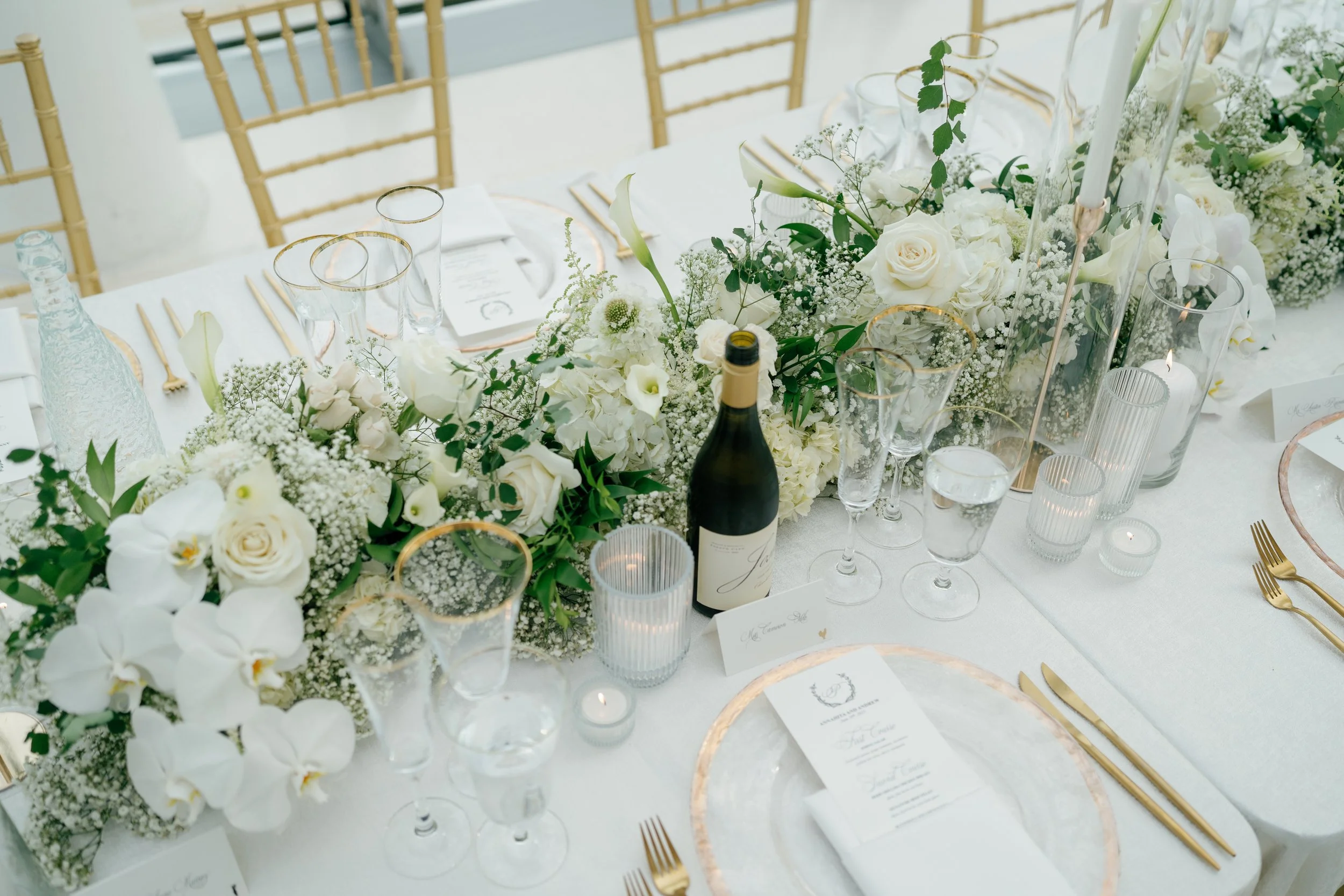 Modern chic spring wedding kauffman center for the performing arts cloud dancer inspiration head table garland tall centerpieces low floral arrangement babys breath orchids calla lilies the cottage rose kansas city wedding florist crossroads