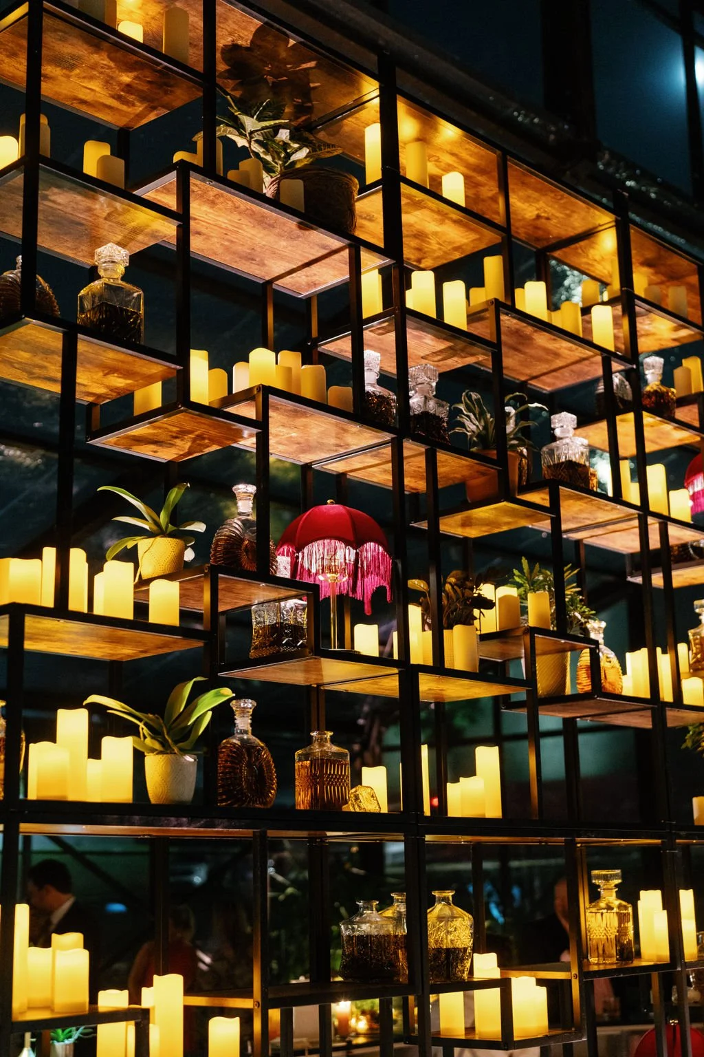 Modern eclectic luxury wedding on the lawn at liberty memorial greenhouse tent wedding outdoor reception fall wedding decor october wedding the cottage rose kansas city wedding florist crossroads  bar shelving candles plants lamps