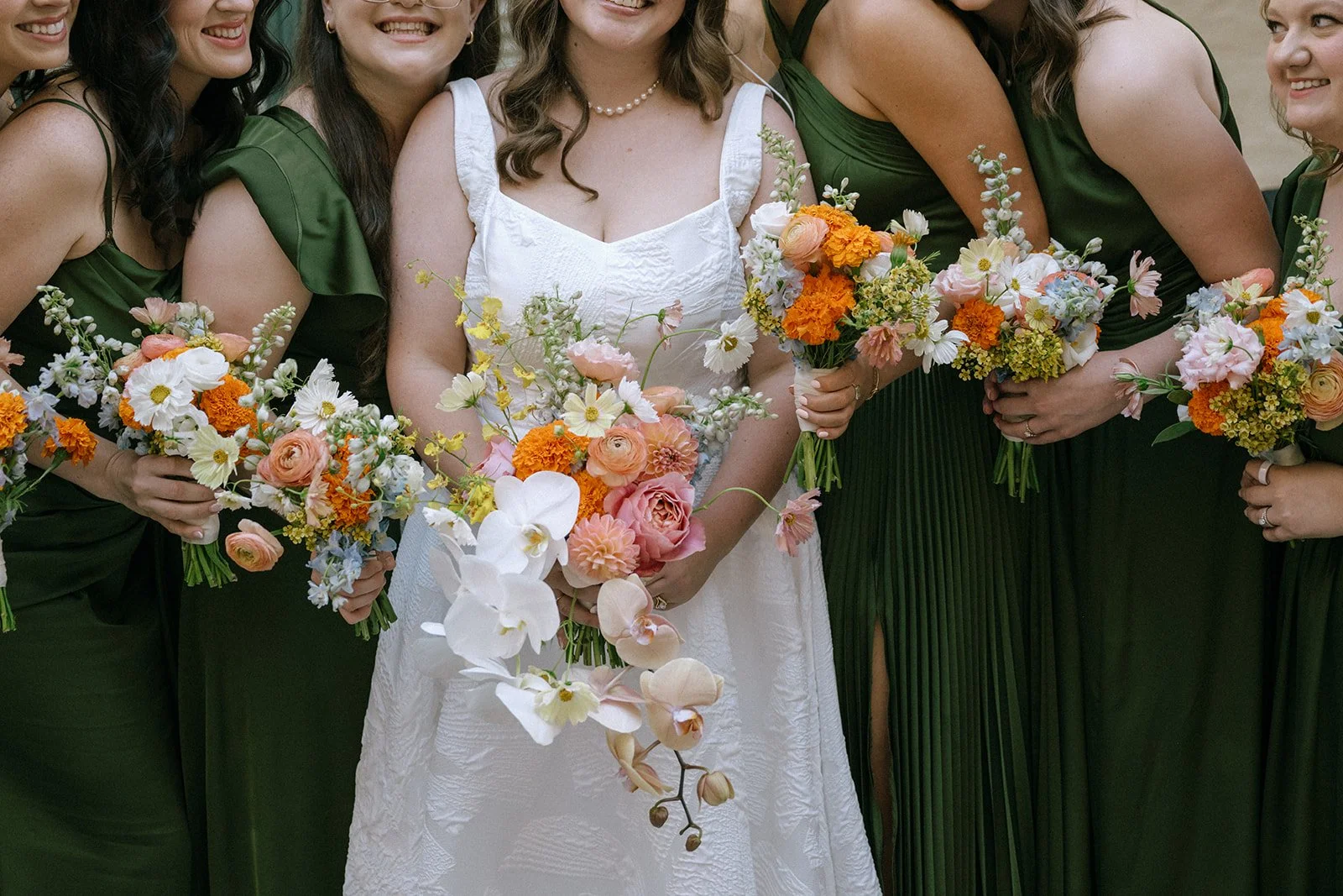 colorful flower filled october wedding in midtown kansas city la villa bridal bouquet wedding bouquet wedding flowers orchids garden roses ranunculus the cottage rose kansas city wedding florist crossroads bride and bridesmaids green dresses