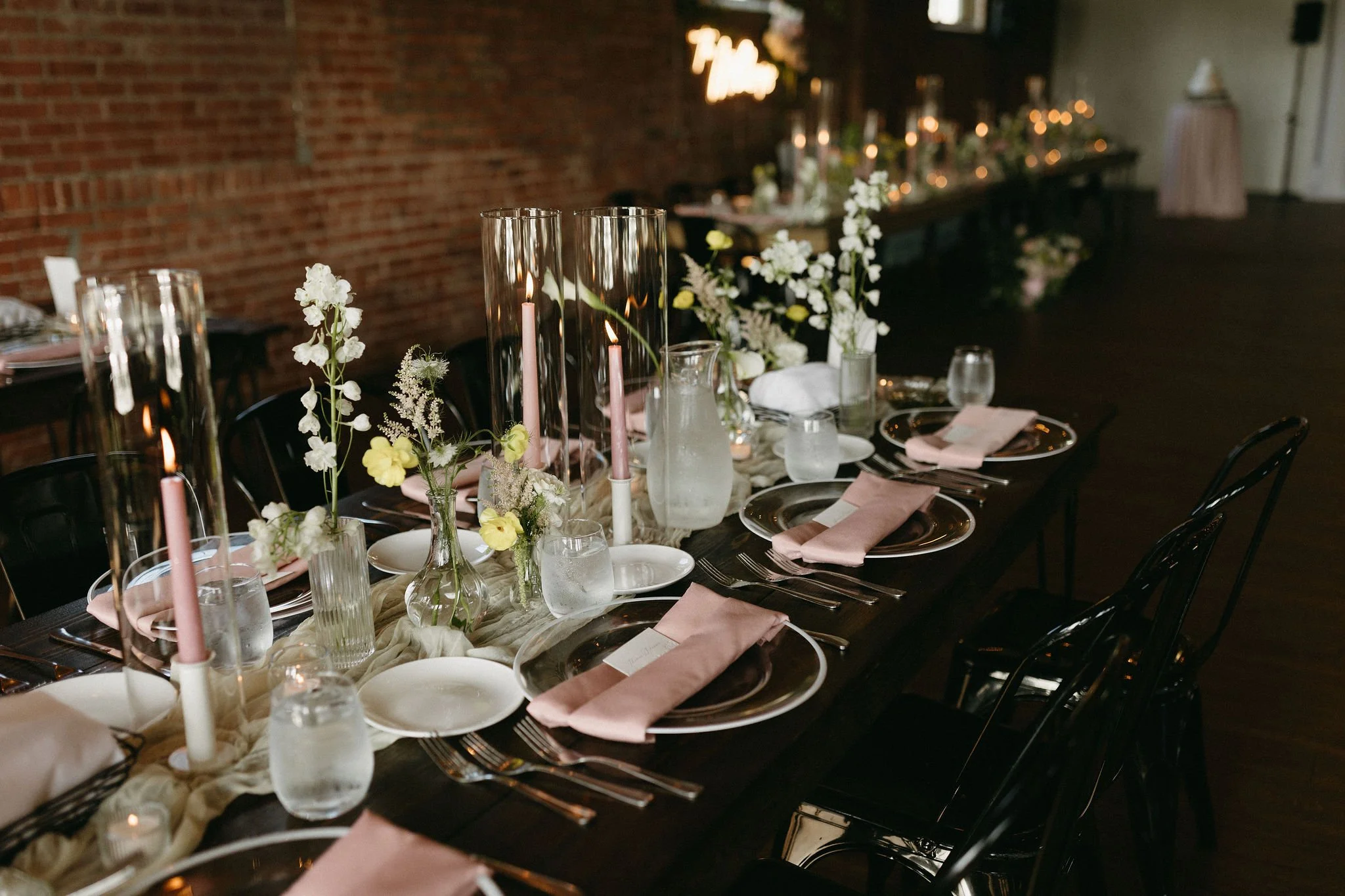 modern spring garden wedding warm color palette yellow peach lilac the cottage rose kansas city florist crossroads powell garden reception hanging greenery bud vases taper candles ikebana flower arrangements centerpieces delphinium