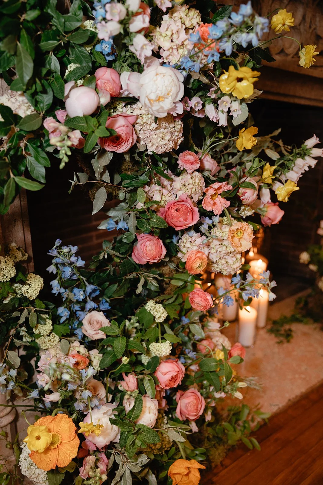 candlelit whimiscal spring garden wedding pastel color palette same sex wedding ceremony fireplace floral installation aisle flowers downtown kc hotel kansas city the cottage rose kansas city wedding florist crossroads