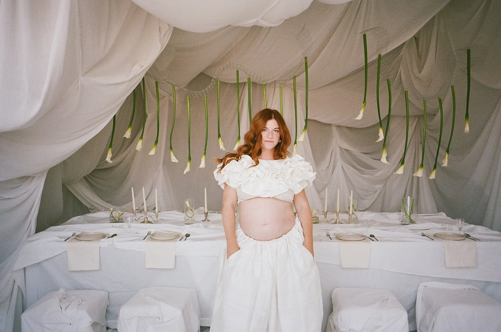 Chic Modern Baby Shower in a Cloud with layers of white draped fabric, simple calla lily centerpieces,  silver candlesticks, hanging floral installation the cottage rose kansas city florist crossroads white set