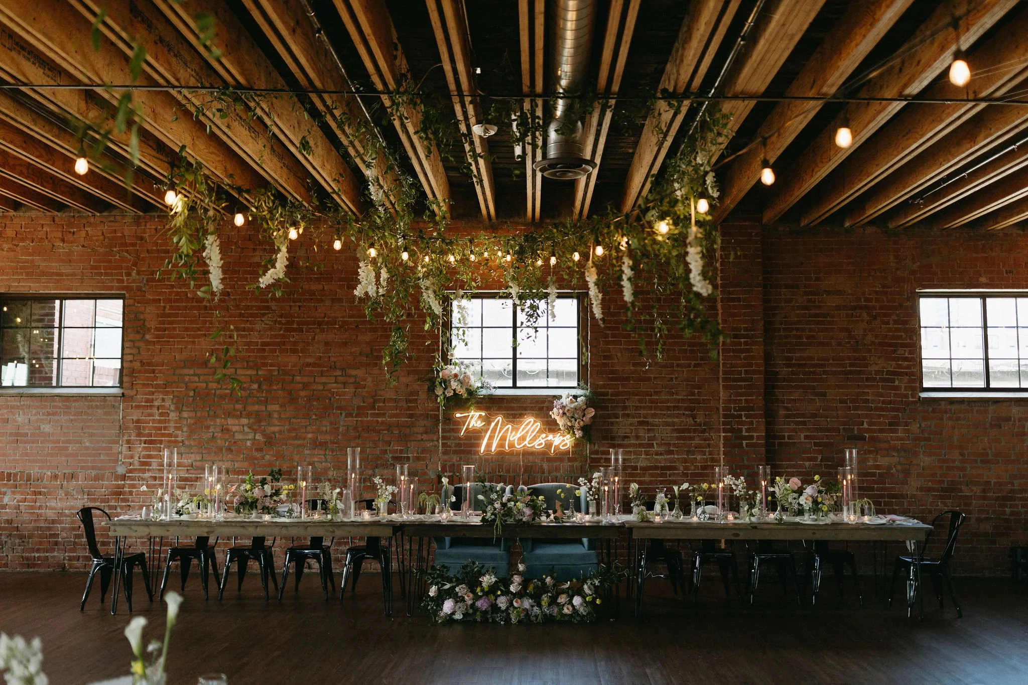 modern spring garden wedding warm color palette yellow peach lilac the cottage rose kansas city florist crossroads powell garden reception hanging greenery bud vases taper candles ikebana flower arrangements centerpieces head table decor