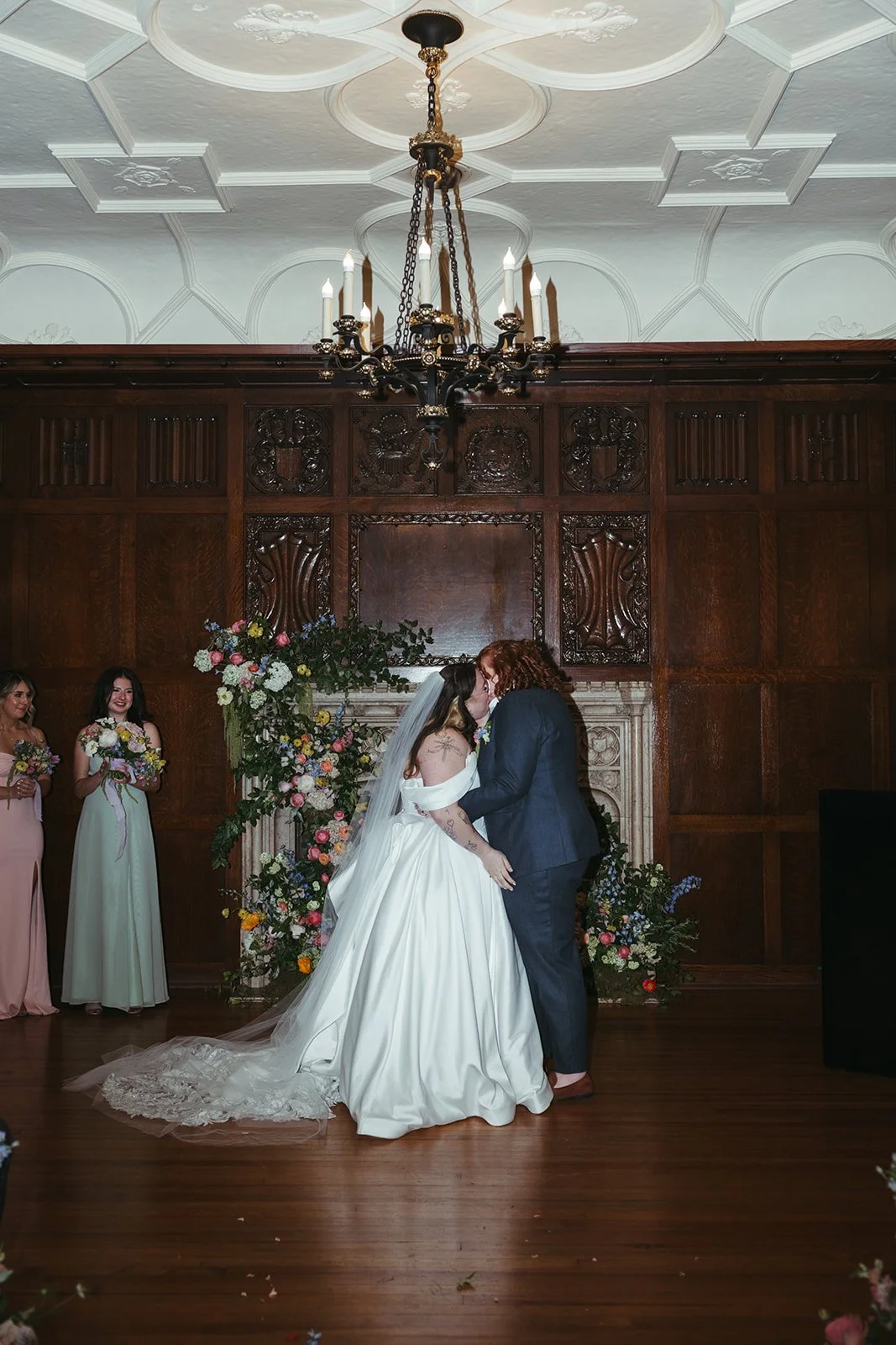 candlelit whimiscal spring garden wedding pastel color palette same sex wedding ceremony fireplace floral installation aisle flowers downtown kc hotel kansas city the cottage rose kansas city wedding florist crossroads