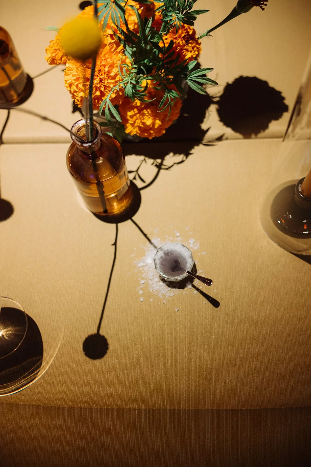 Modern september wedding reception orange and yellow color palette craspedia bud vases centerpieces silver candelabra  the cottage rose kansas city wedding florist crossroads hotel kansas city wedding orange marigold ikebana arrangement centerpiece