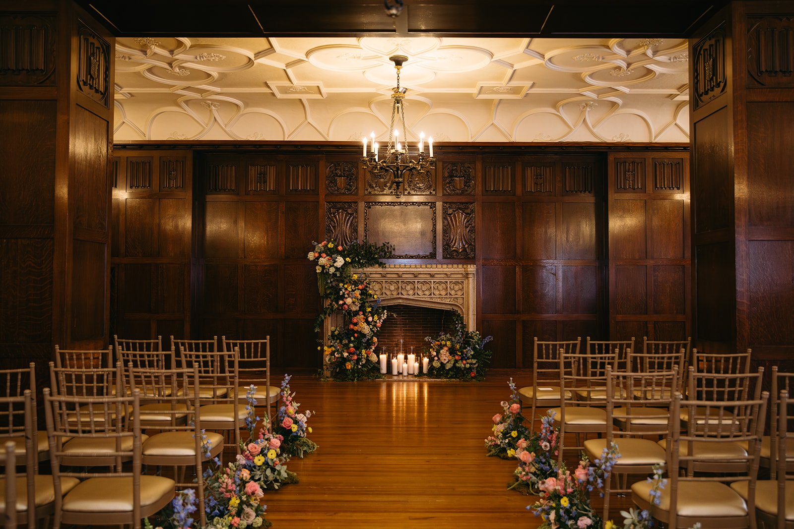 whimiscal spring garden wedding pastel color palette same sex wedding ceremony fireplace floral installation aisle flowers downtown kc hotel kansas city the cottage rose kansas city wedding florist crossroads