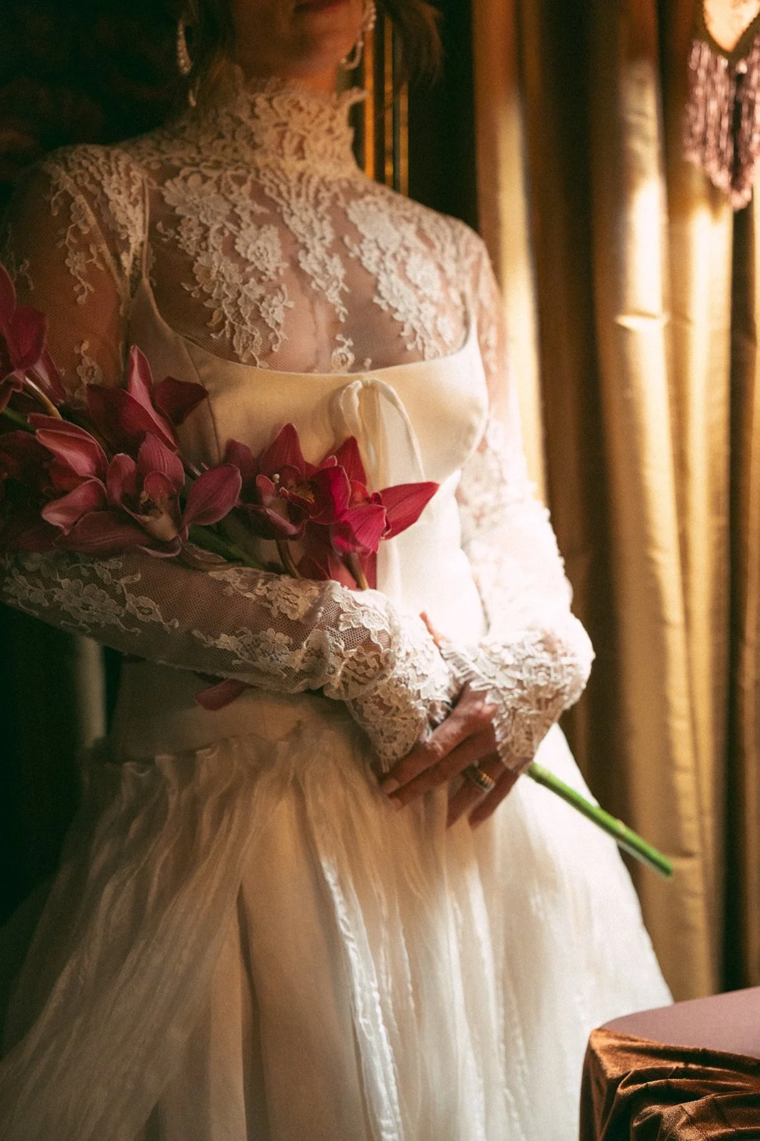 Vintage maximalist more is more wedding inspiration full lush florals pop of red modern victorian lace bridal look le lounge kansas city wedding florist the cottage rose crossroads spring wedding decor brown fabric orchids amaranth bride kc