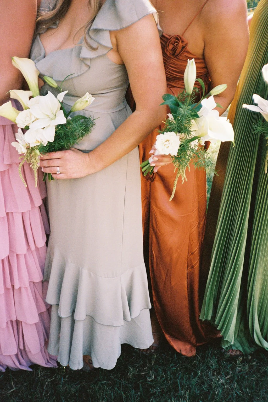 Modern eclectic luxury wedding on the lawn at liberty memorial greenhouse tent wedding outdoor reception fall wedding october the cottage rose kansas city wedding florist crossroads bridesmaids colorful dressed white and green bouquets callas