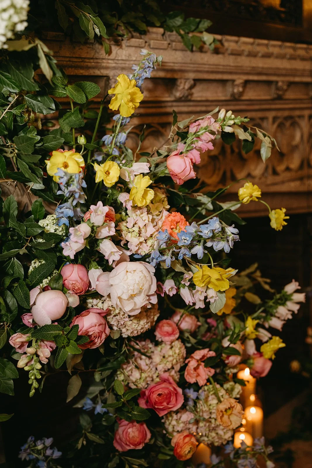 candlelit whimiscal spring garden wedding pastel color palette same sex wedding ceremony fireplace floral installation aisle flowers downtown kc hotel kansas city the cottage rose kansas city wedding florist crossroads