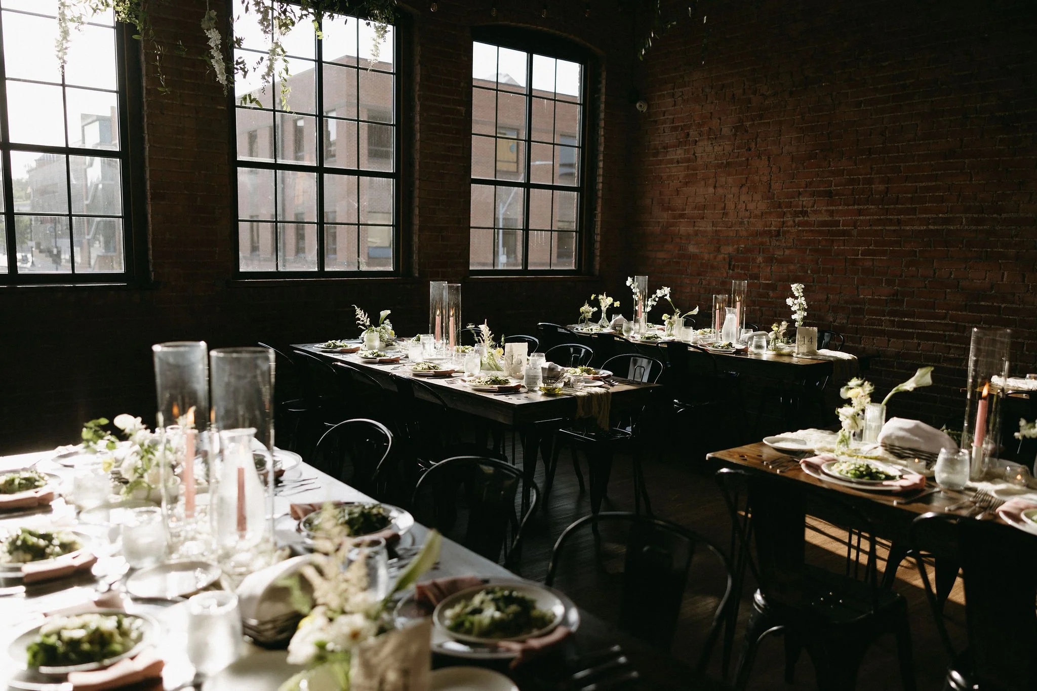 modern spring garden wedding warm color palette yellow peach lilac the cottage rose kansas city florist crossroads powell garden reception hanging greenery bud vases taper candles ikebana flower arrangements centerpieces