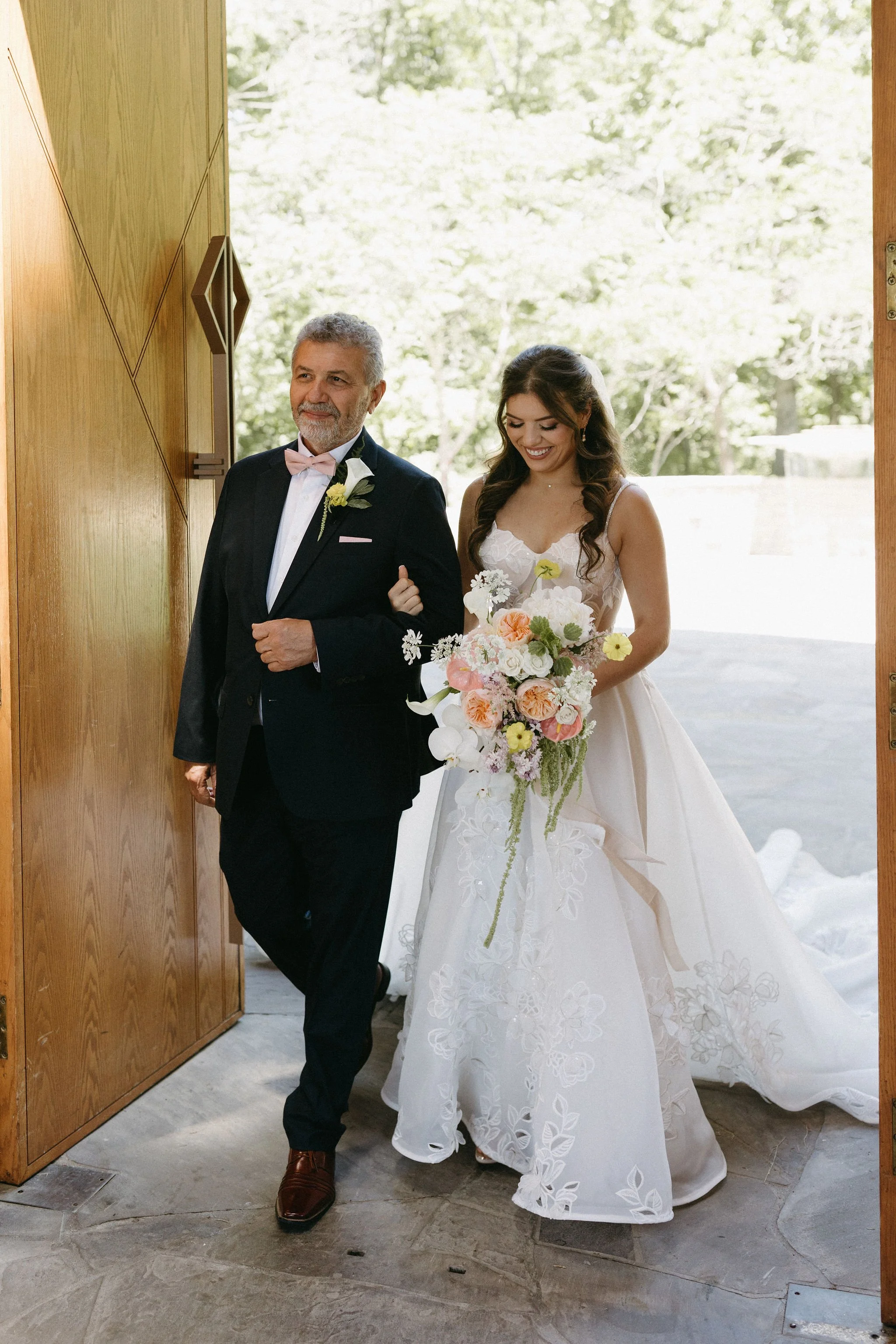 modern spring garden wedding warm color palette yellow peach lilac the cottage rose kansas city florist crossroads powell garden ceremony father and bride in ballgown large statement bouquet yelllow peach lilac